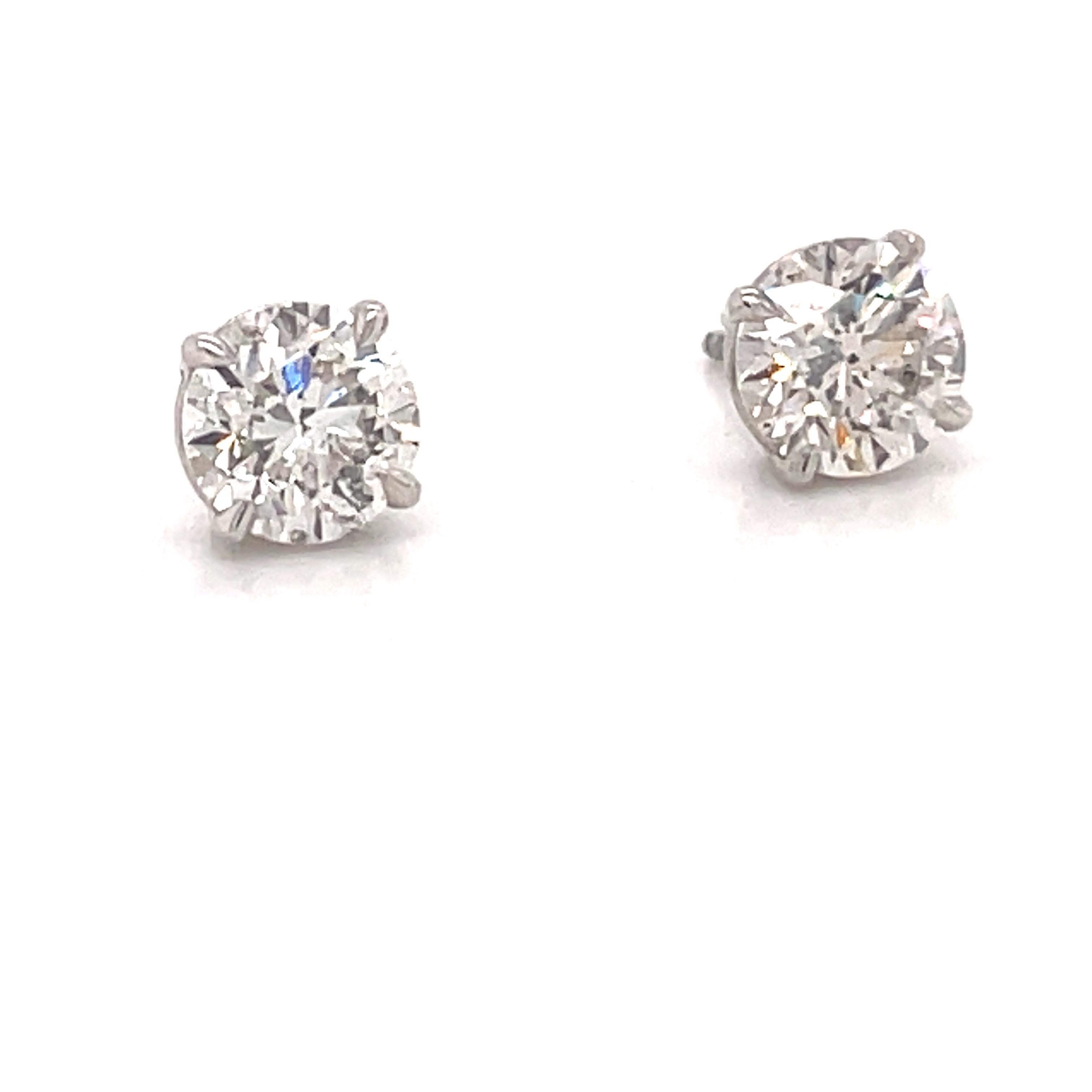 Diamond stud earrings weighing 2.04 carats in a 4 prong champagne setting, 14k white gold. 
Color I
Clarity SI3-I1