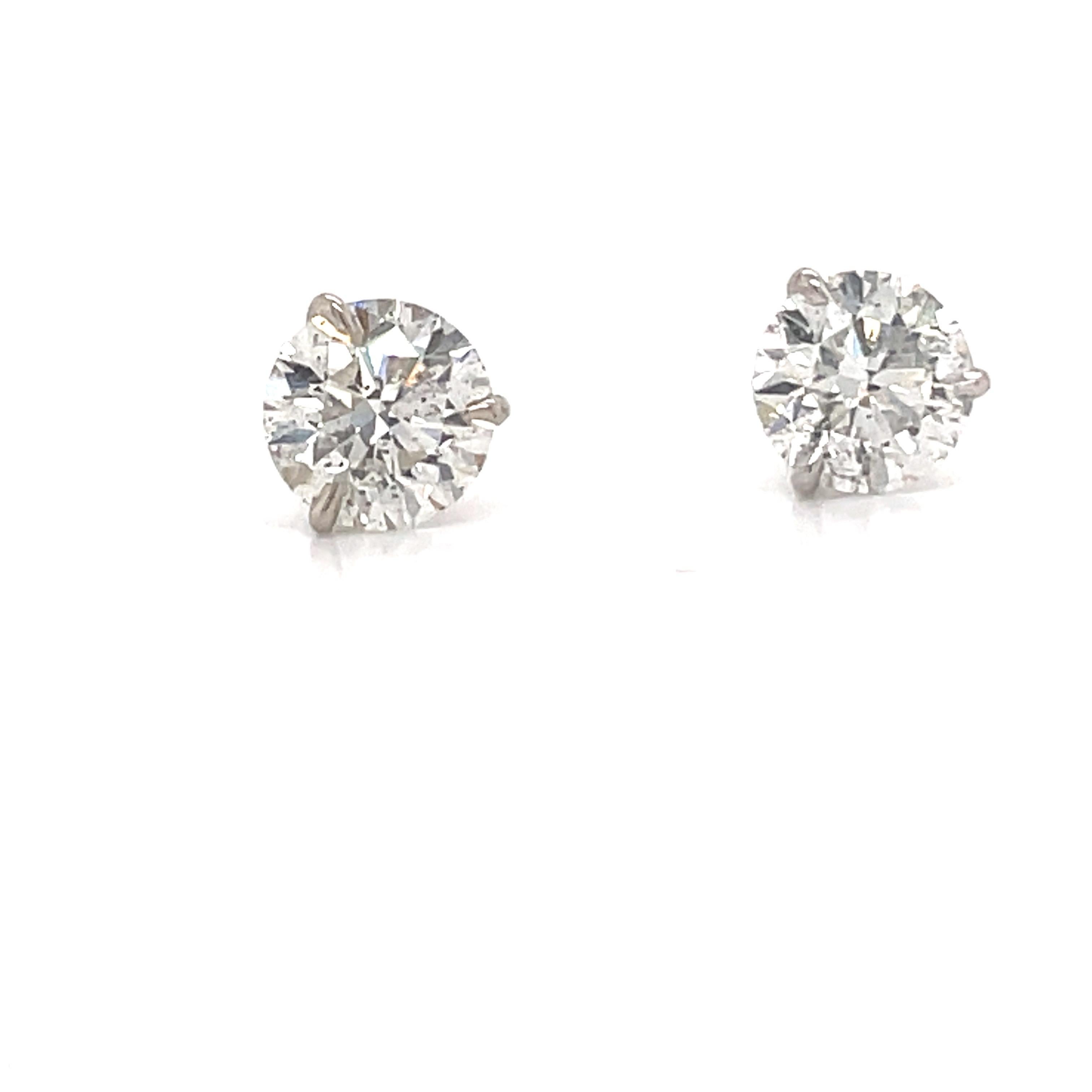 Diamond stud earrings weighing 4.06 carats in a 3 prong champagne setting, 18k white gold. 
Color G-H
Clarity SI3-I1