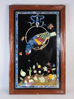 Hard stone panel depicting a parrot with a butterfly and plant motifs, Italy