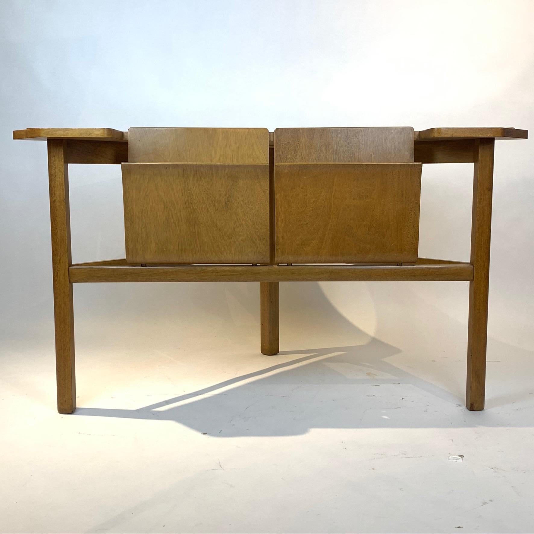 A seldom offered Dunbar corner/magazine table designed by Edward Wormley with bent plywood magazine or record compartments .Labeled with warm original finish and patina.