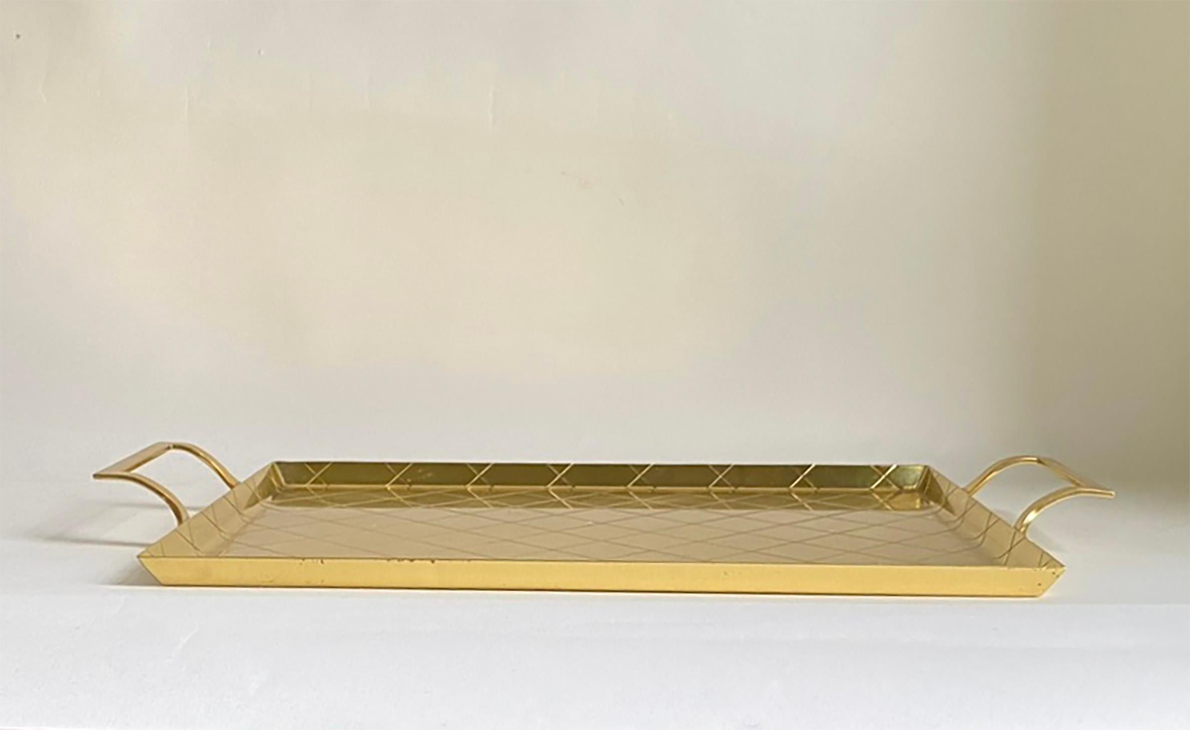 Here is a very attractive brass tray that barely comes to market by the 20th century great, Tommi Parzinger. This tray was designed around 1960 for Dorlyn Silversmiths, which was located on Lafayette Street In Manhattan. The tray is in good