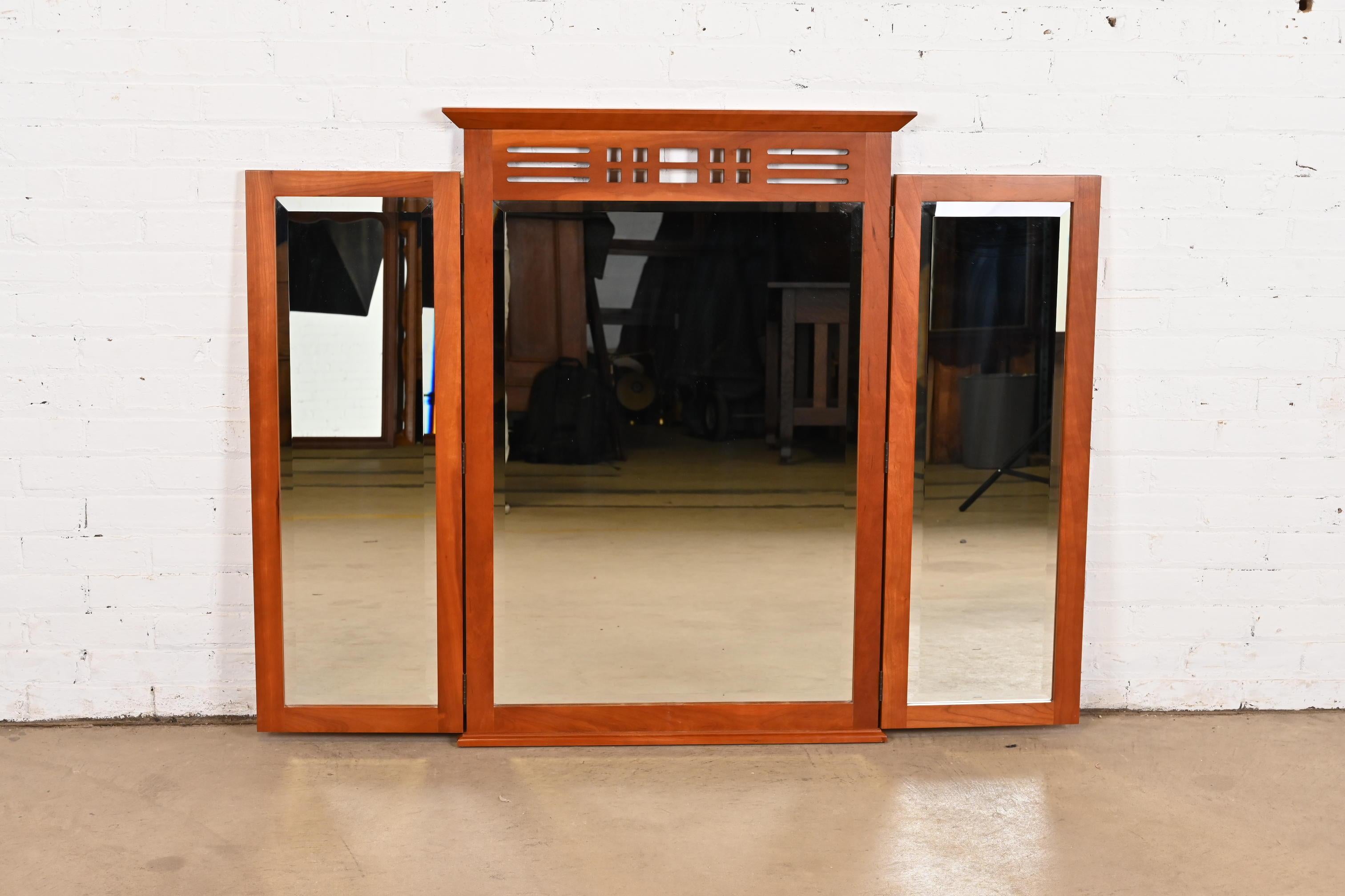 A gorgeous Arts & Crafts or Shaker style tri-fold triple mirror

By Harden Furniture

USA, Late 20th Century

Carved solid cherry wood frame, with beveled glass triple mirror.

Measures: 55.25