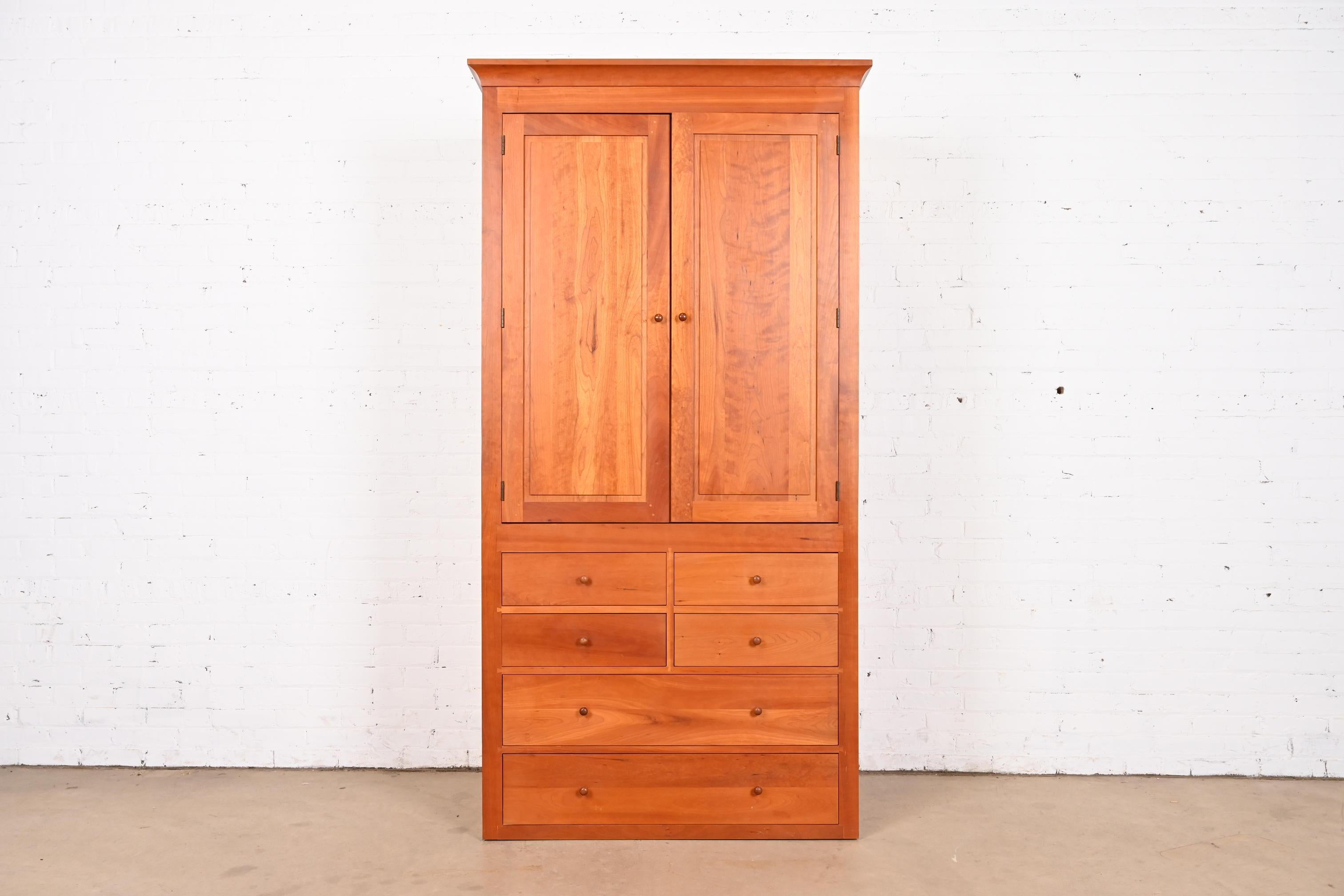 An exceptional Arts & Crafts or Shaker style solid cherry wood armoire dresser, gentleman's chest, or linen press

By Harden Furniture

USA, Late 20th Century

Measures: 42