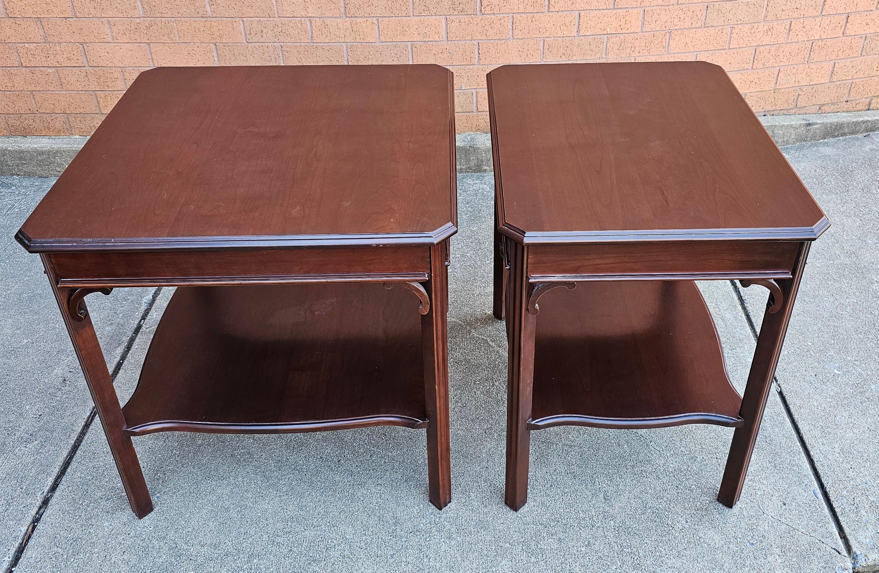 A gorgeous pair of  Harden Furniture Chippendale Solid Cherry two Tier Side Tables with Protective Glass Tops in pristine condition. 2004 vintage in Like new condition.
Larger table measures 26