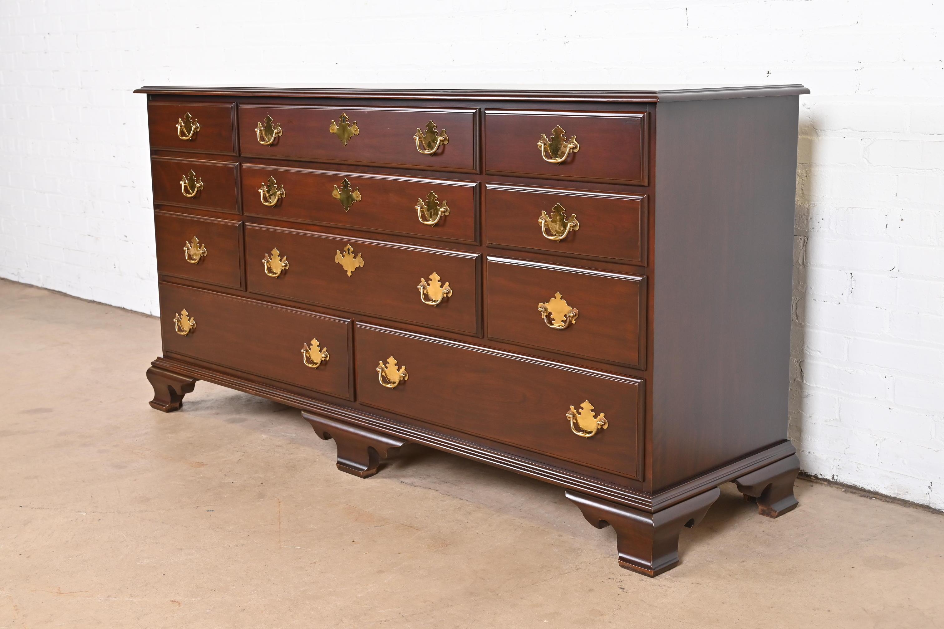 An exceptional Georgian or Chippendale style long dresser

By Harden Furniture

USA, Late 20th Century

Solid carved cherry wood, with original brass hardware.

Measures: 66.75