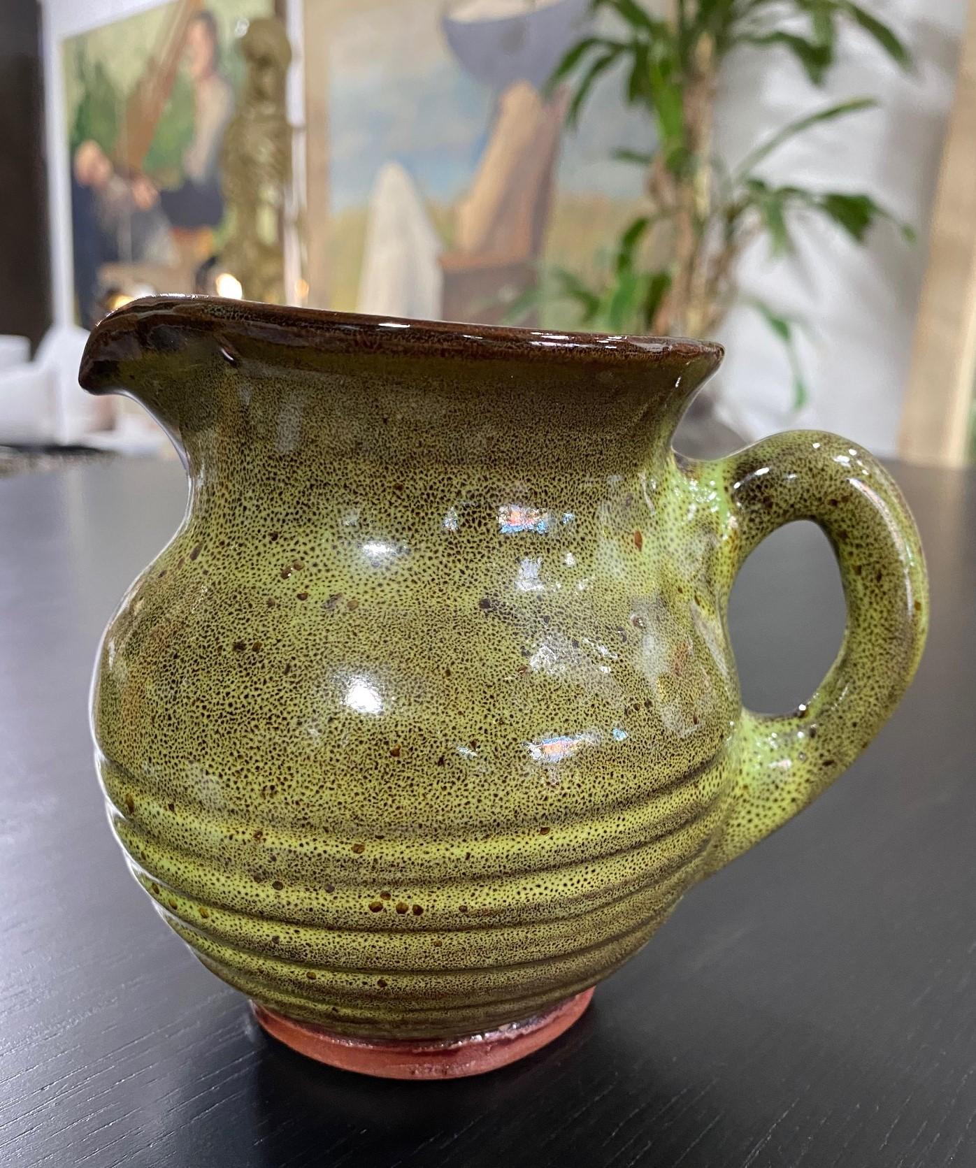 A hand-thrown, well-crafted, piercing green glazed ceramicpitcher by famed Texas-born San Antonio ceramic master Harding Black. A perfect combination of form and function. 

Signed and dated (1983) by the Black on the base. 

This work has a