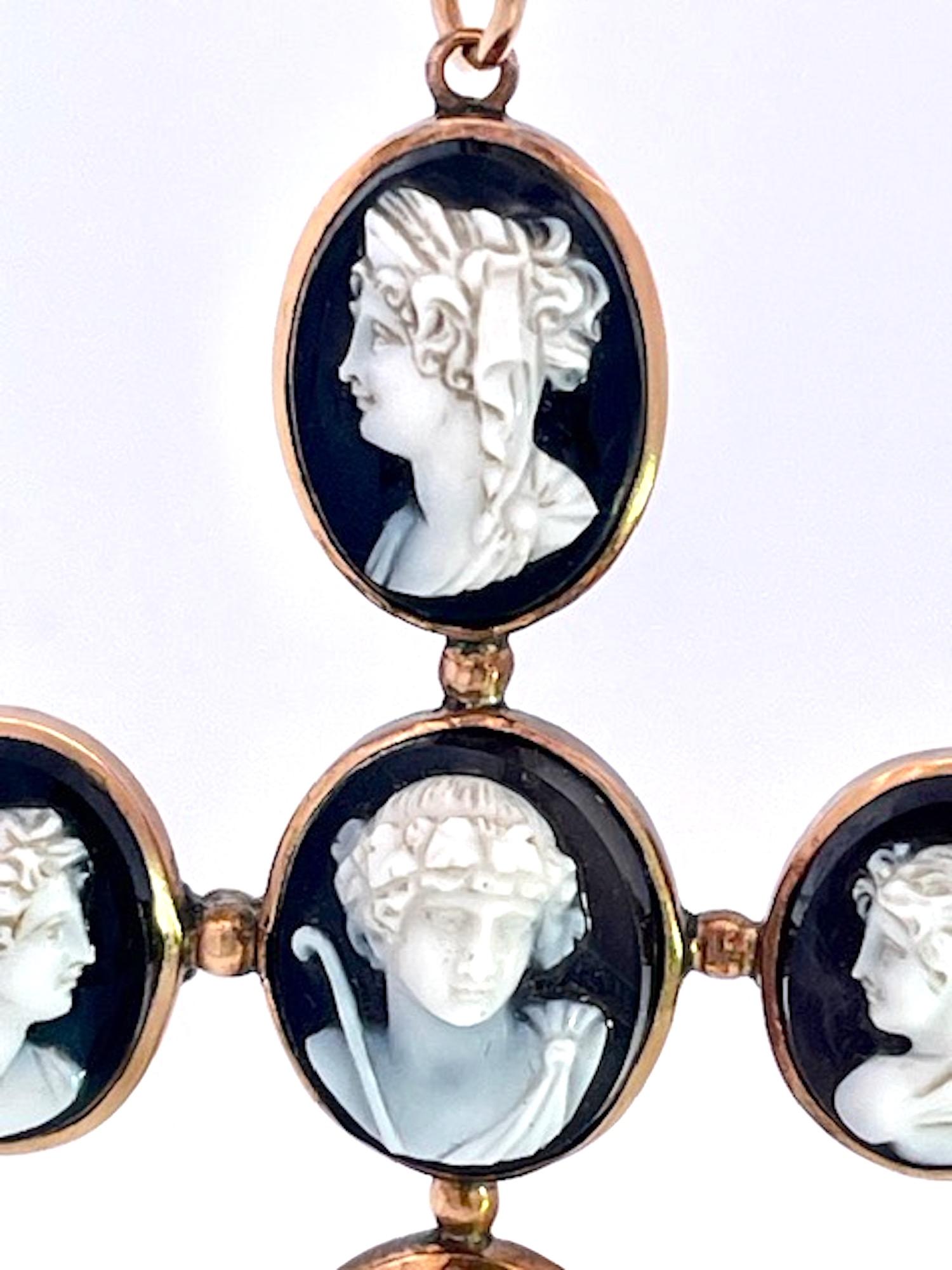 This amazing cross pendant is from the 1860's and it is magnificent.There are 6 hardstone Cameos depicting classical Greek figures, in the center probably Dionysus accompanied by a retinue of female followers, mounted in 14K yellow gold.  I have