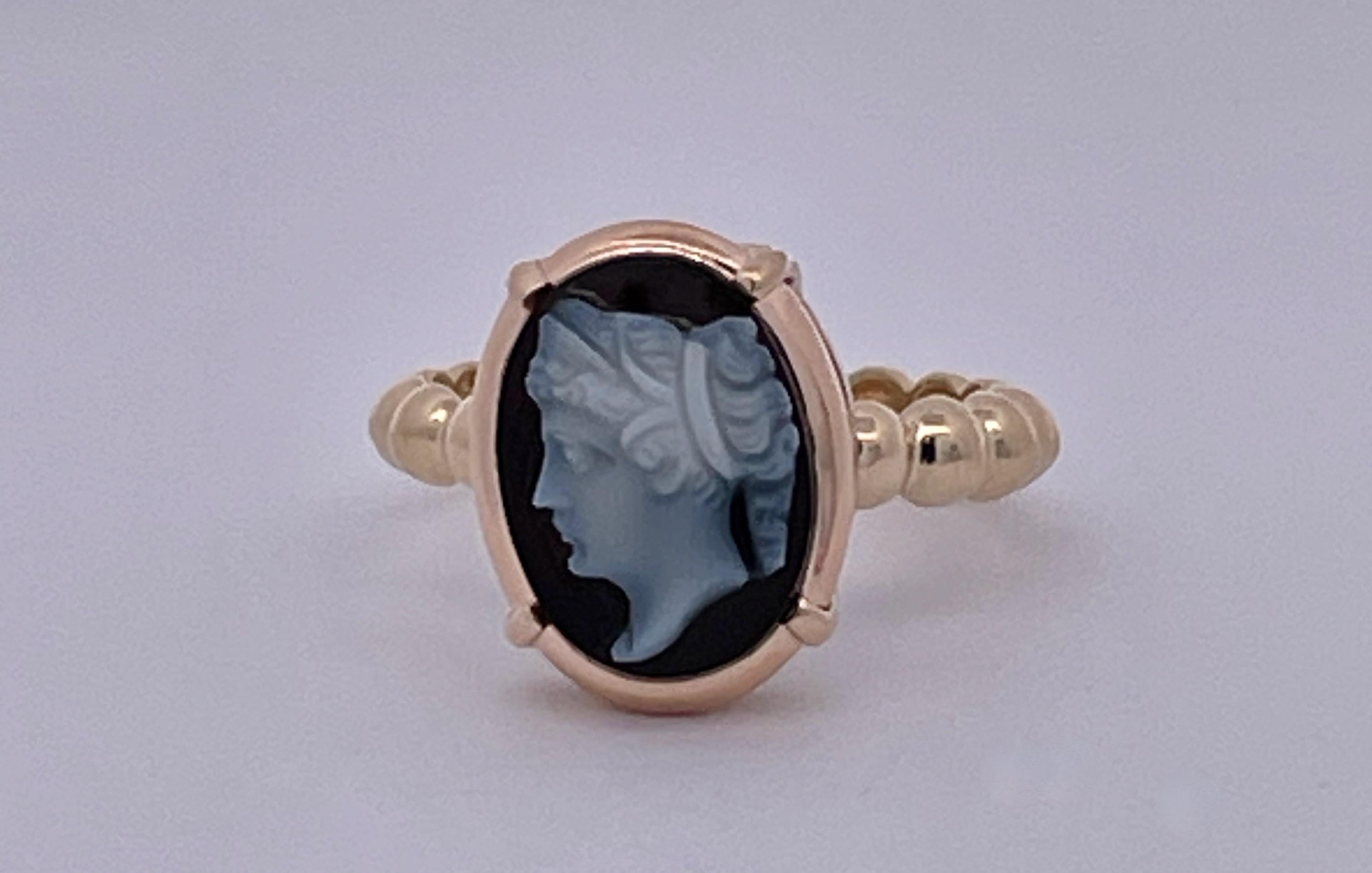 This lovely ring started life as a stick pin but I changed it into a lovely ring.  This portrait of a lady is carved on top this hardstone and a nice everyday ring.  The size is six and can be resized if needed. It is done in 14K yellow gold and the