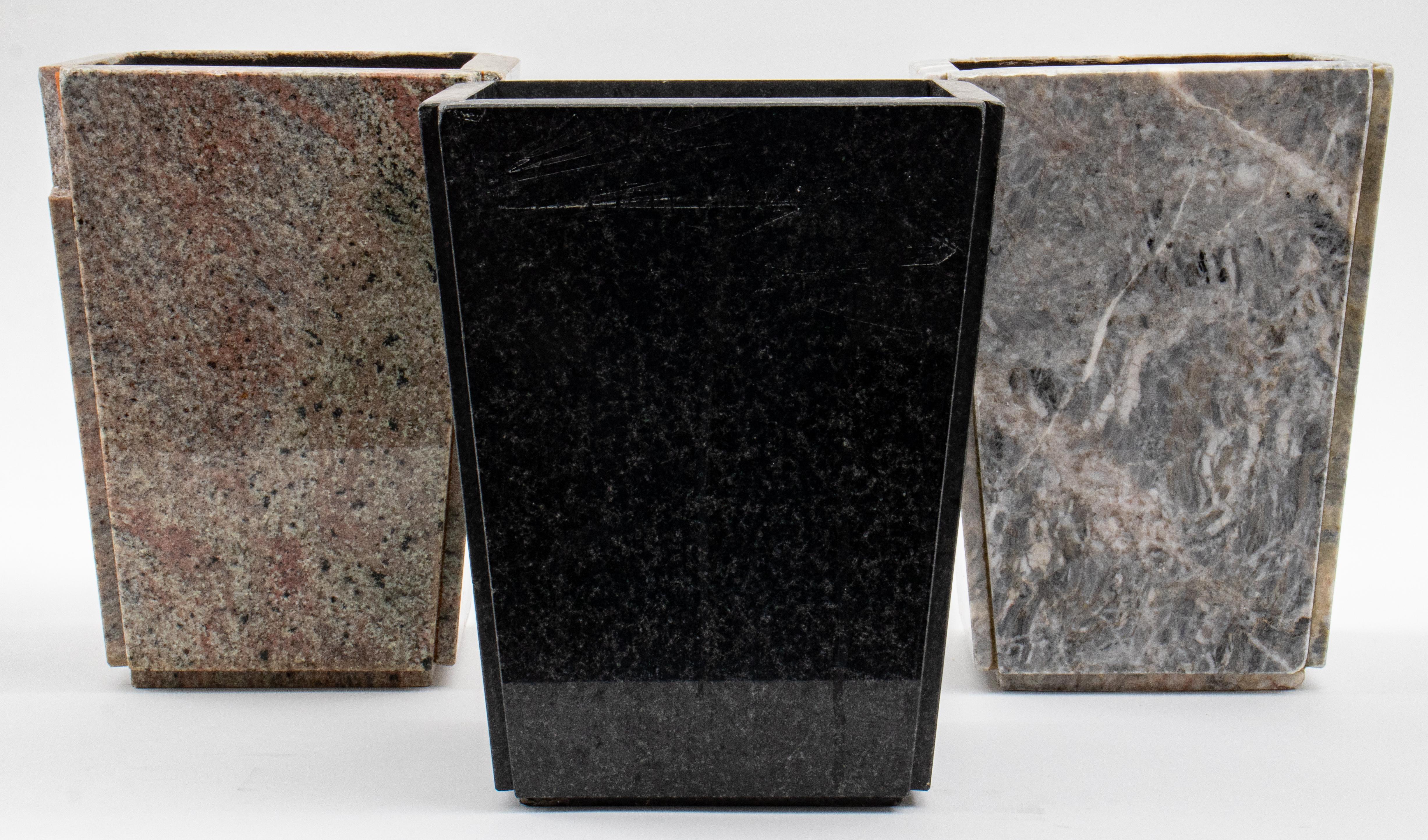 Three hardstone mounted planters or bathroom trash cans, of tapered rectangular form, one black granite, one mottled gray and red possibly marble, and one gray marble. 11.75