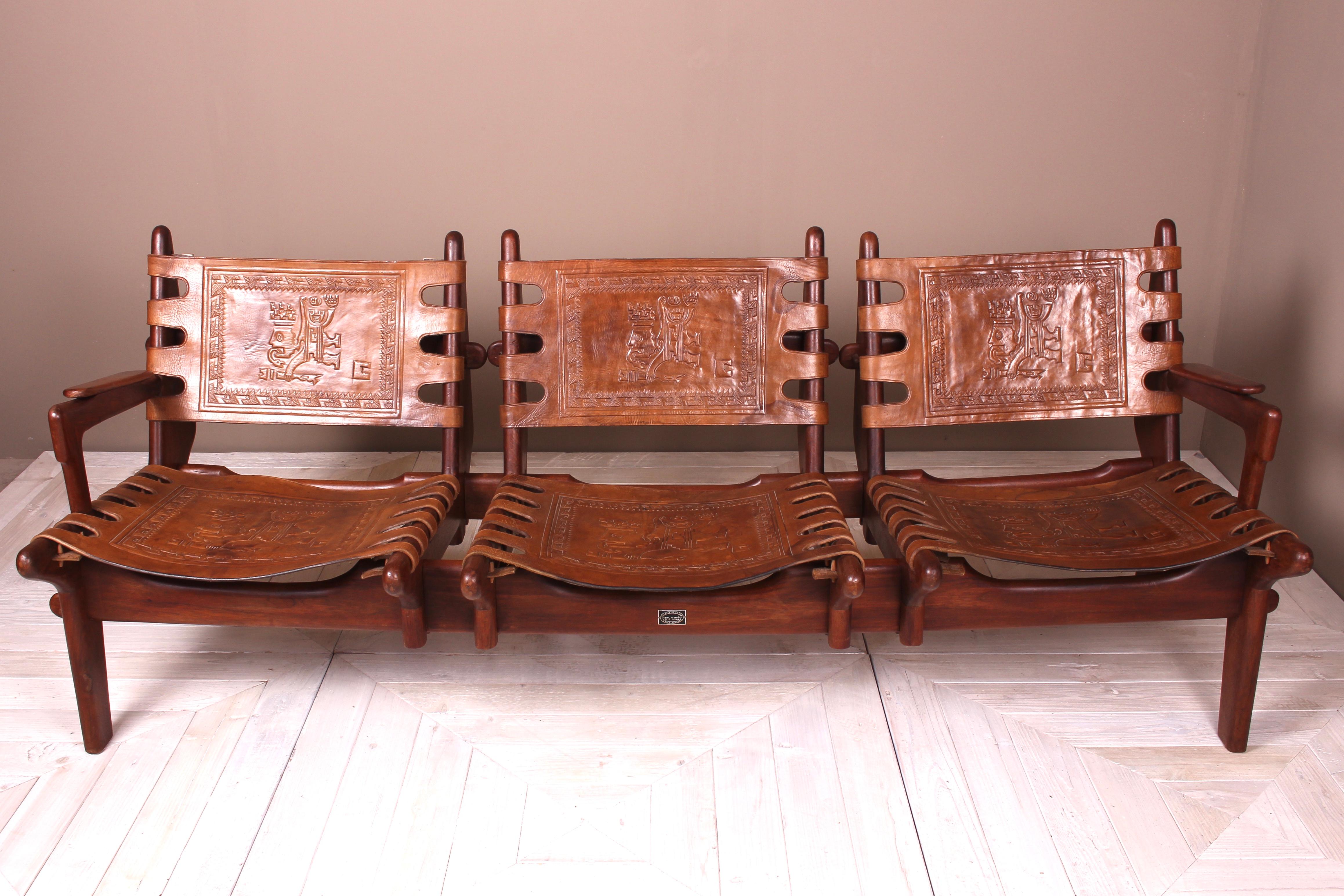 A stunning early 1960s Angel Pazmino for Muebles de Estillo Ecuadorian three-seat settee in rosewood with saddle brown leather. Featuring solid rosewood peg construction, original heavy cowhide with delightful Mayan embossed designs to seat and