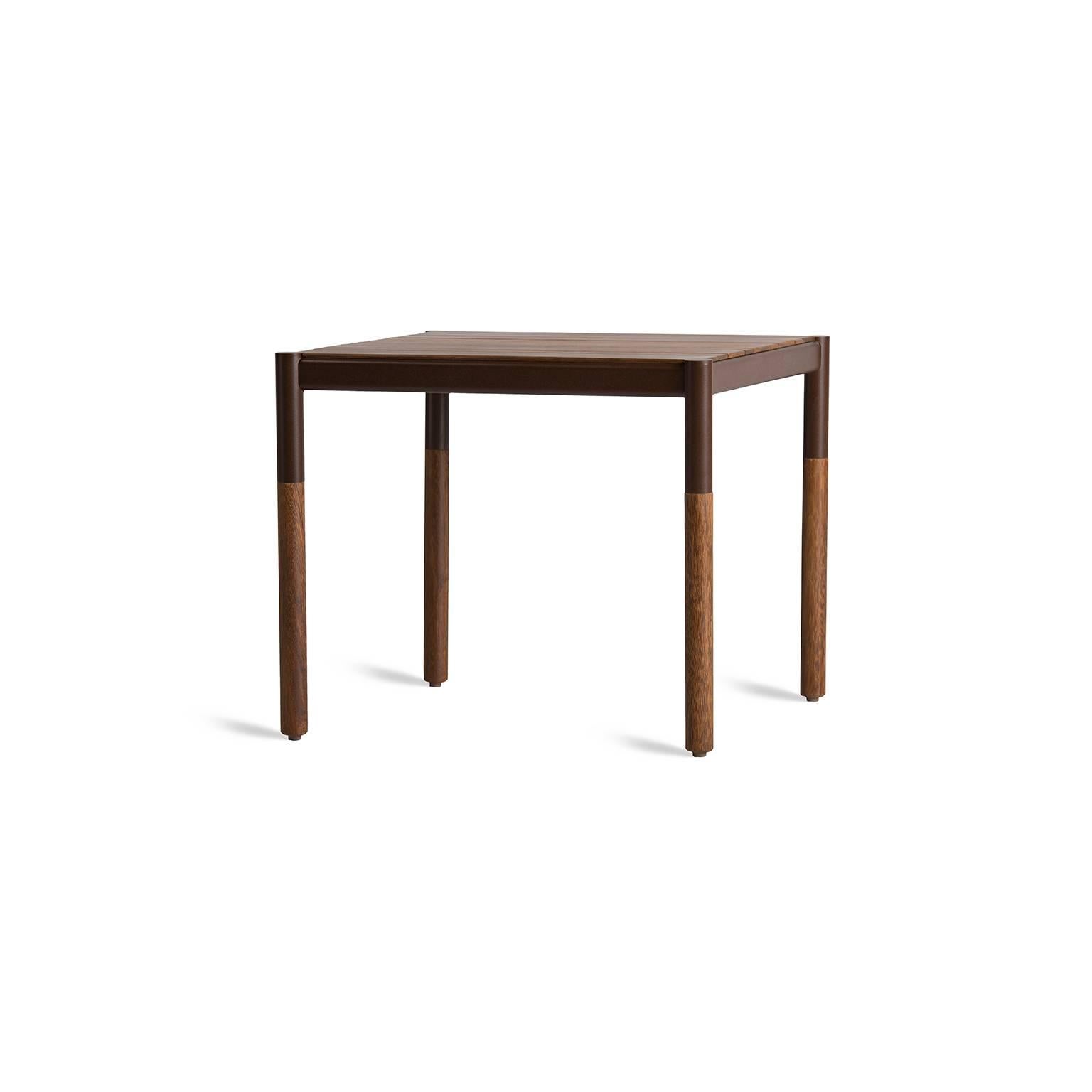 Theis side table is made for outdoor use. The side table is produced in metal in a minimalist design, it is a side table that combines thin solid wood thickness with a heavy duty body, uniting the sweet and mellow appearance of the top with the