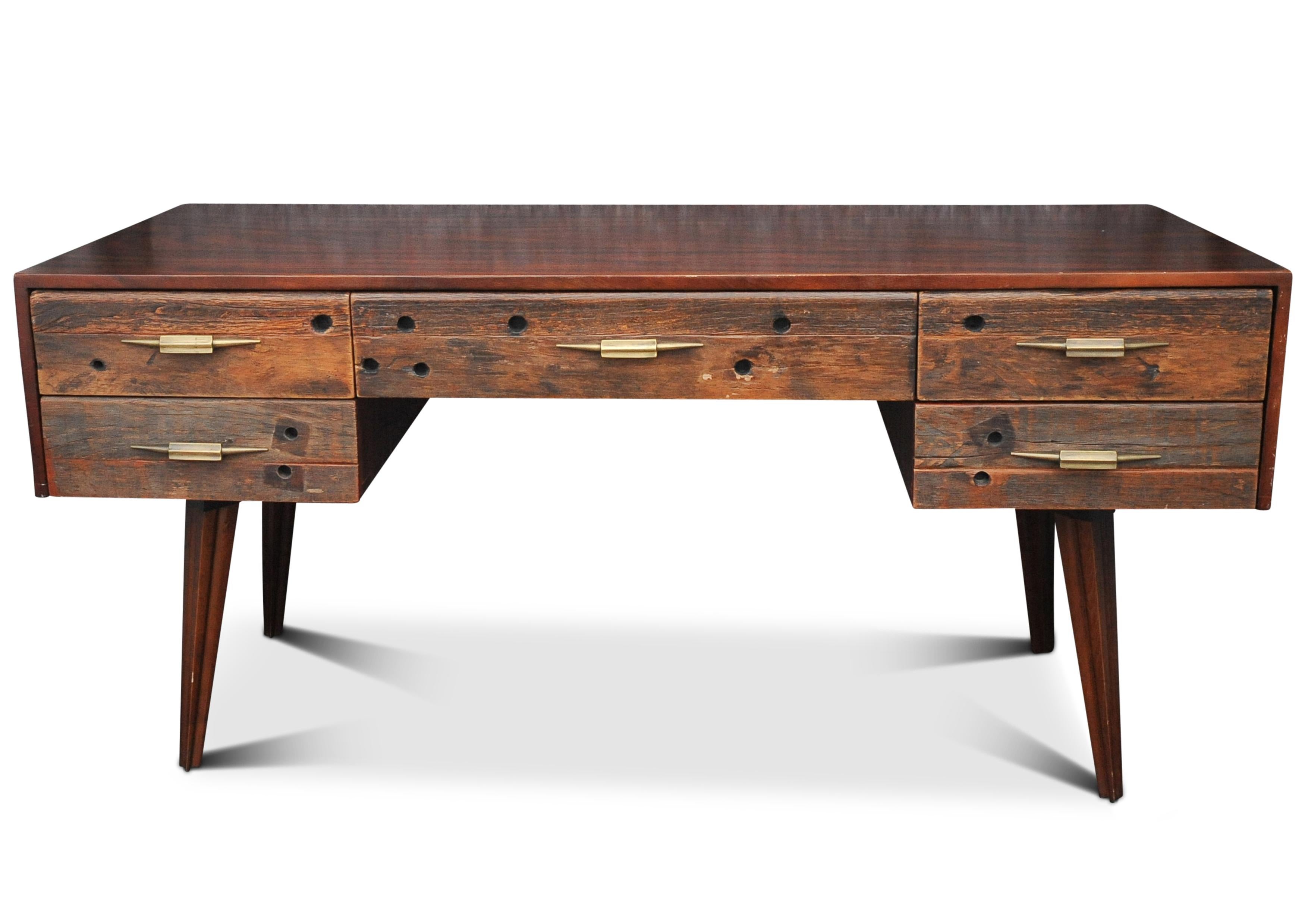 An Impressive Hardwood & Reclaimed Timber Desk Befit With Five Drawers & Gilded Handles.
The external frame tips it's hat to midcentury, the drawer handles reflect and a more art deco styling.

Will work great in a commercial or home