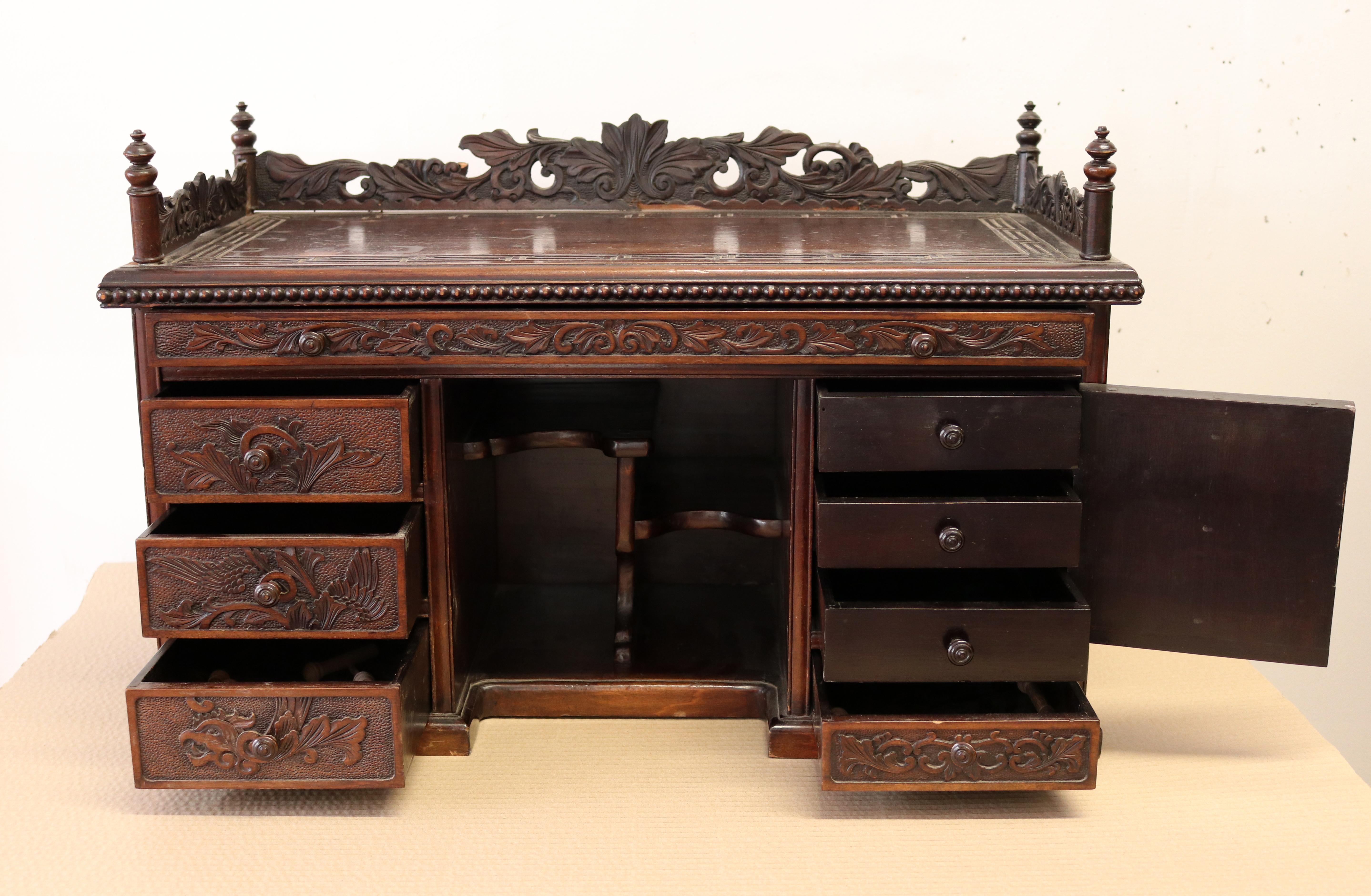 Wood carved chest with drawers and cupboard.
Beautifully carved gallery of small size, ideal for setting on a desk.
Of the very highest quality, circa mid-late 1800s.
Lacquered drawers, sides and bottoms. 

Measurements: 
L 82cms
H 41cms
W