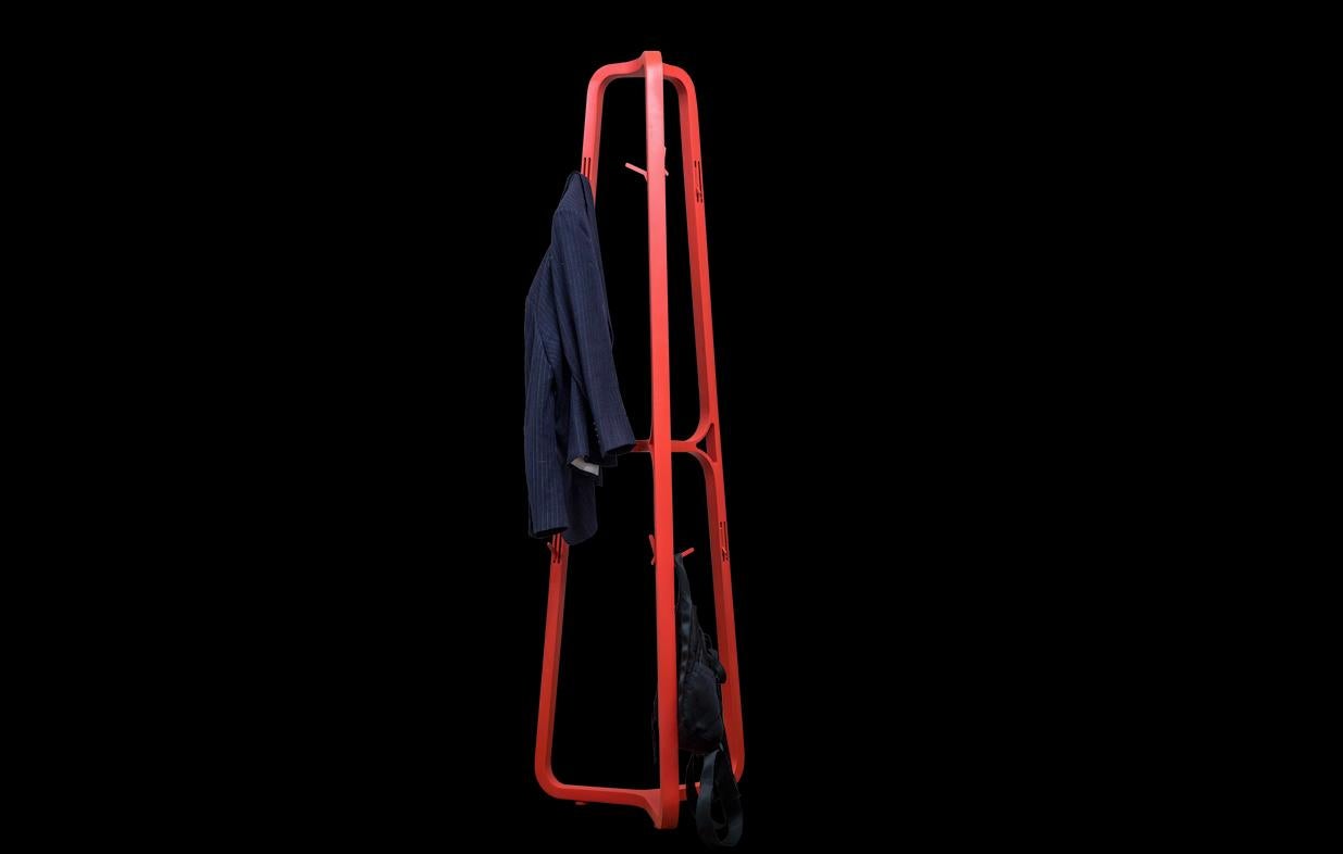 A playful coat rack made of Mexican wood finished with mate lacquer, features 12 holding hooks installed in a mechanism within the structure of the coatrack, that fold in and out to hang clothing and handbags.
    
