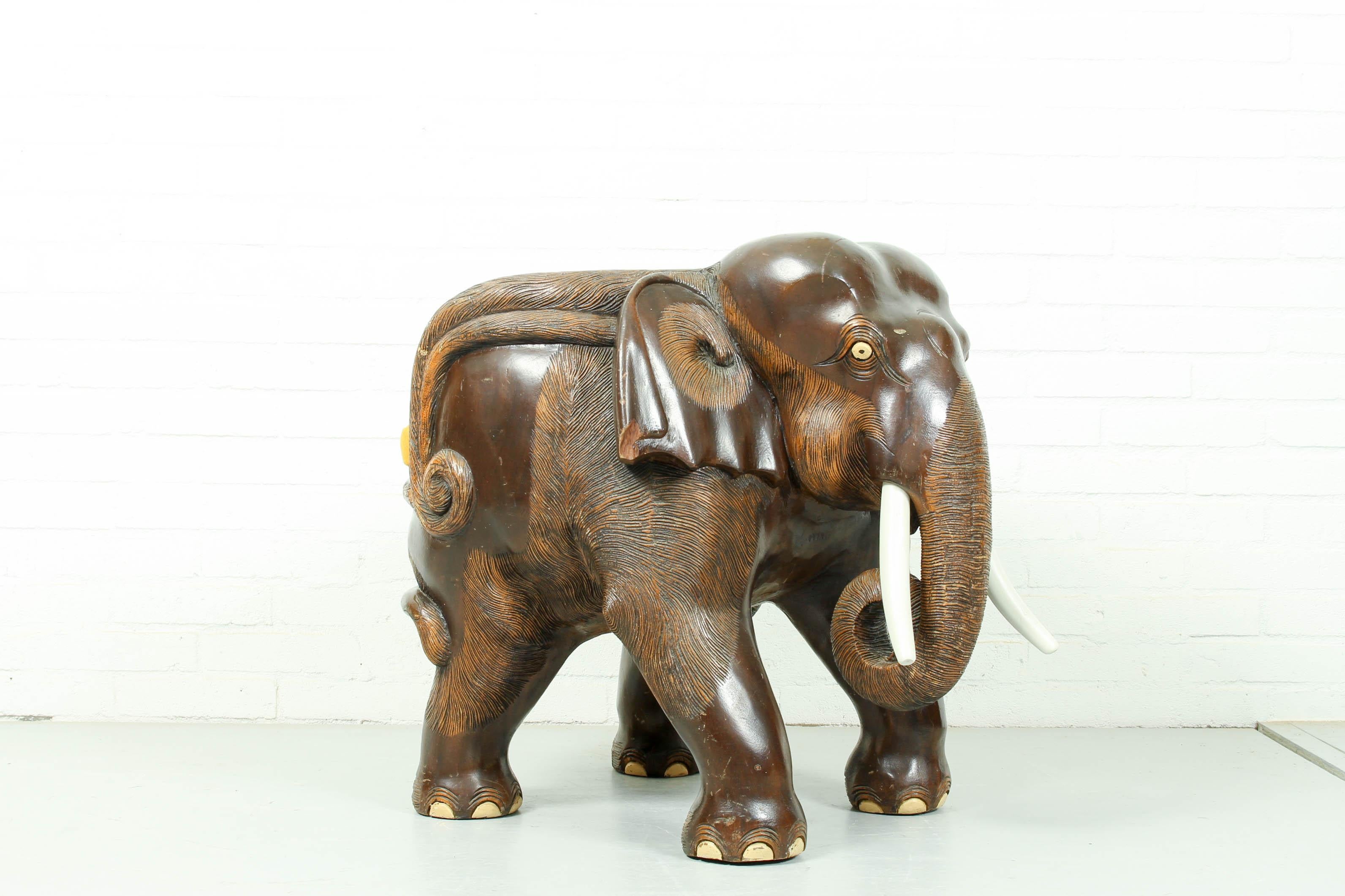 Hard wood chair sculpted as elephant, dark brown. Great for children's room.
  