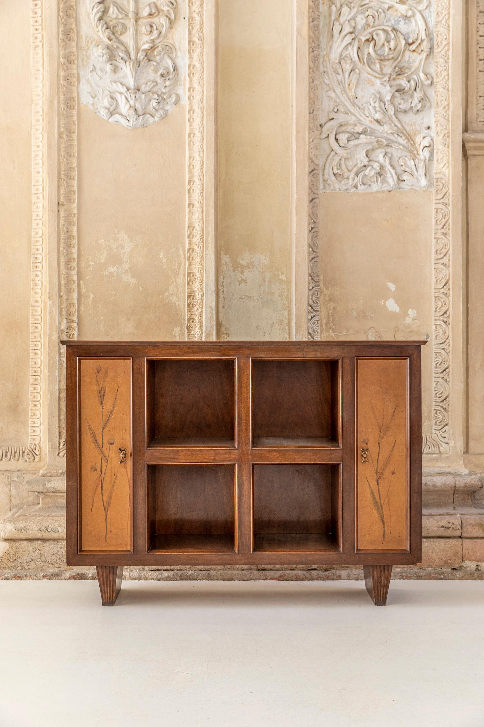 Walnut cabinet or sideboard attributed to Osvaldo Borsani. 
This sideboard has four central square compartments and two side doors, each of which has inside tree shelves. Hand painted parchment doors and sides.
Peculiarity of this item are the