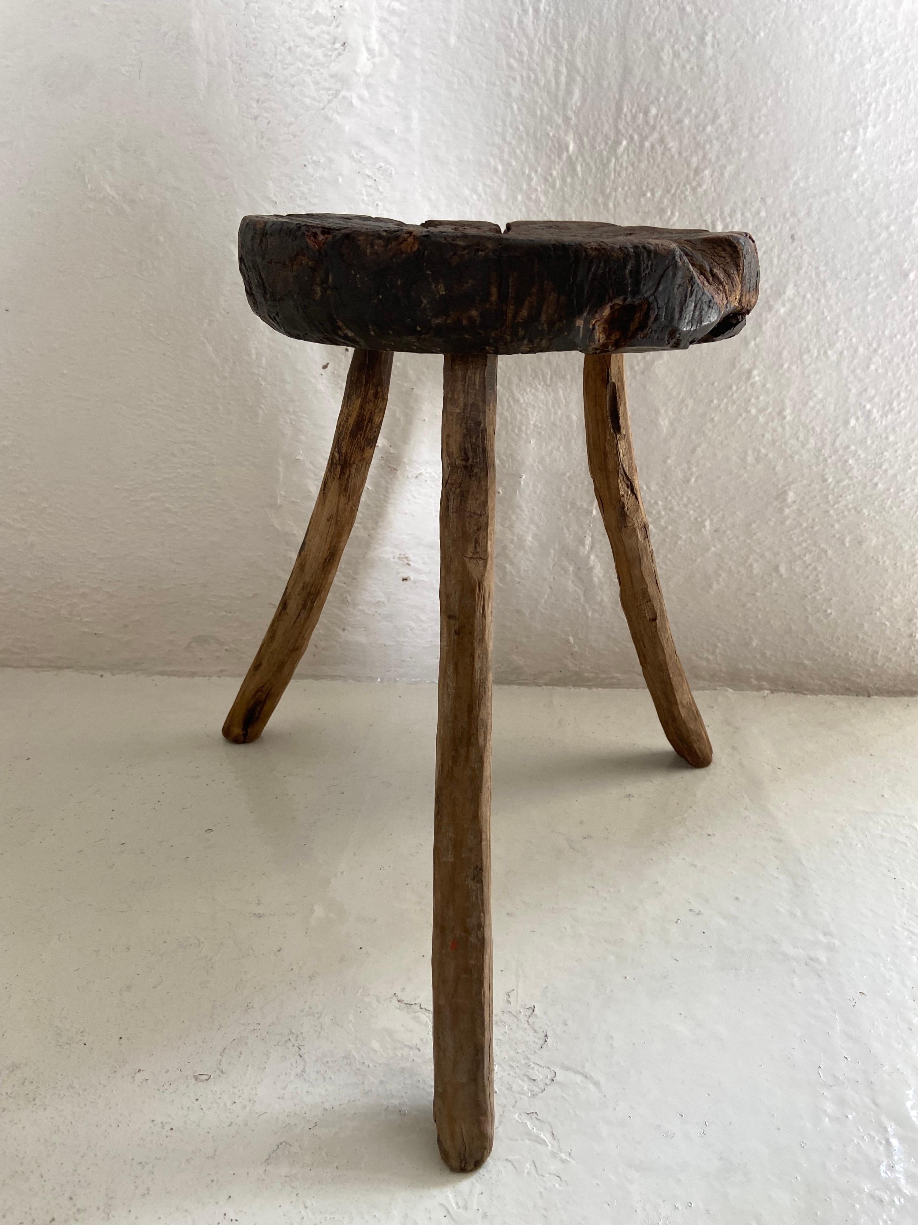 19th century mesquite hardwood stool from Mexico. All original legs. This piece shows much wear with an unusually dark, weathered seat from years of use. Completely primitive in style. The stool was acquired from San Luis Potosí.
