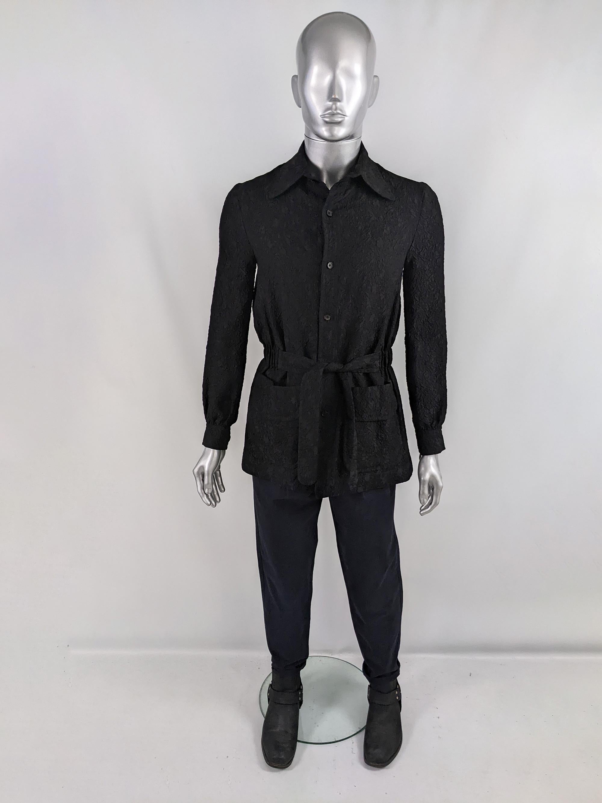 An incredibly rare and stylish vintage mens shirt / lightweight jacket from the 60s by British couturier and Savile Row tailor, Hardy Amies. In a black textured cloqué fabric with a half belt at the front and an elasticated back creating that