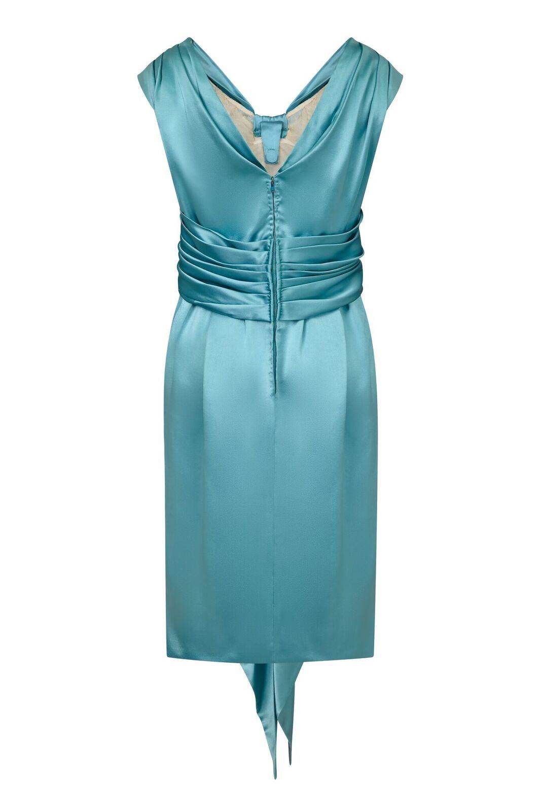 This 1950s Hardy Amies couture label rich silk satin occasion dress in pale aquamarine perfectly showcases the skill and refinement for which its designer is extolled. Celebrated for opulent occasion wear in structured silks, Amis was a favourite of