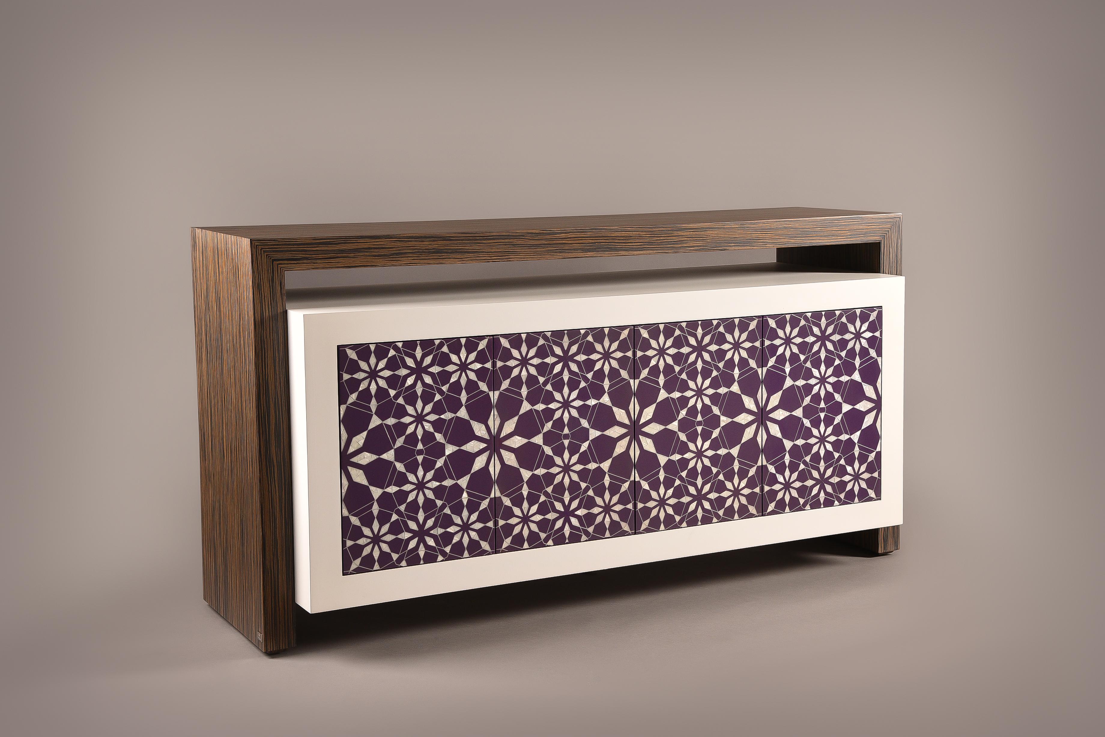 Harem is a sideboard that intercepts the classical Arabic patterns and handcrafted techniques with modern clean design lines. The four door unit cabinet in Ebony wood frame and colored cabinet is hand-inlaid with mother-of-pearl and