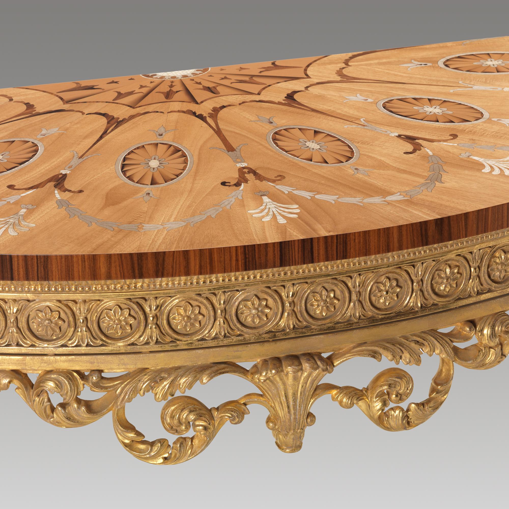 A fine Chippendale George III design fruitwood, tulipwood, marquetry and giltwood pier table. The semi-elliptical top centred to the rear edge by a sunflower and fan motif with six oval patera framed within bell-flower garlands and anthemia with a