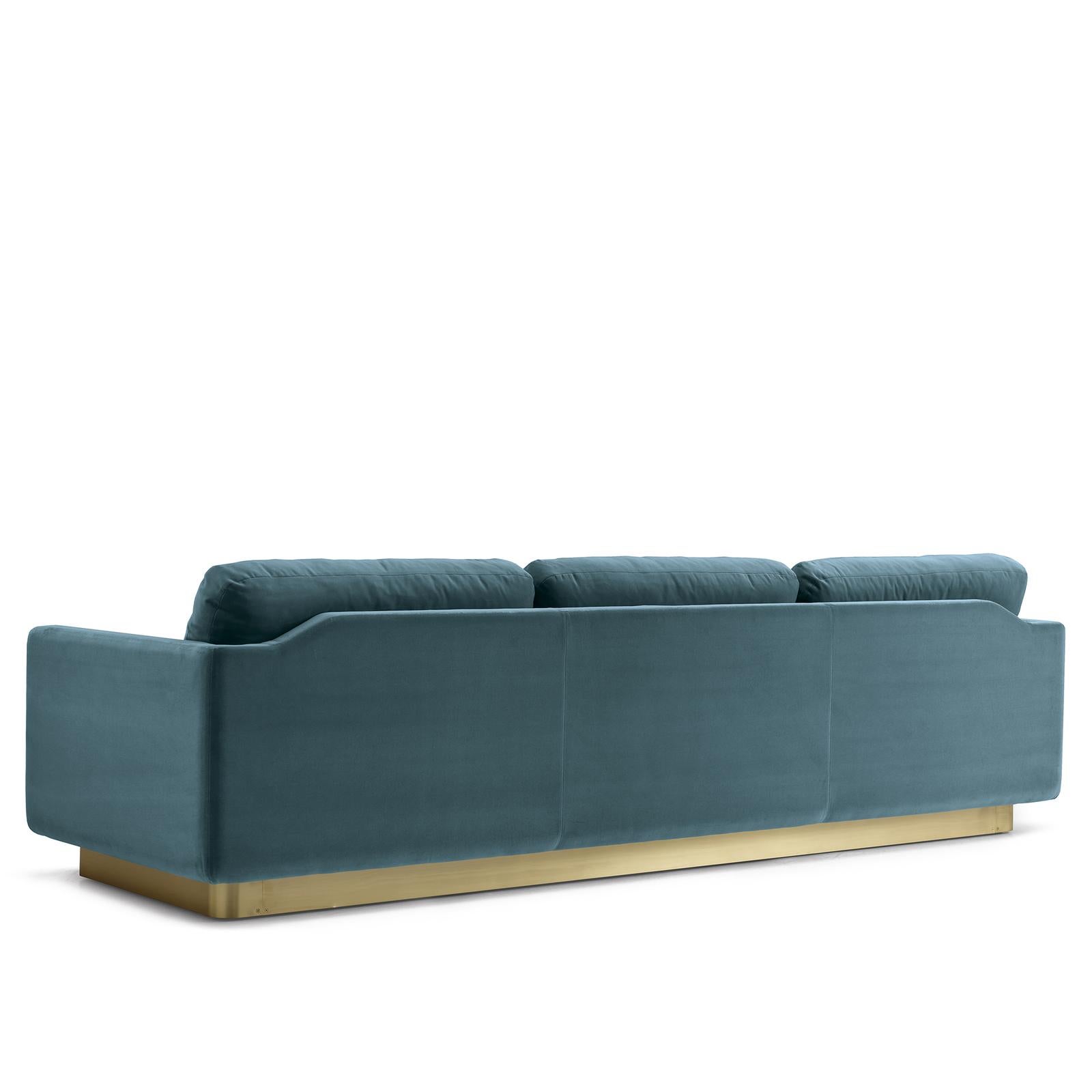 The clean, essential design of this sofa exudes subtle sophistication and a versatile profile. Resting on a satin brass base, the 3-seat structure is padded with multi-density rubber covered with a layer of memory foam and goose feathers, and
