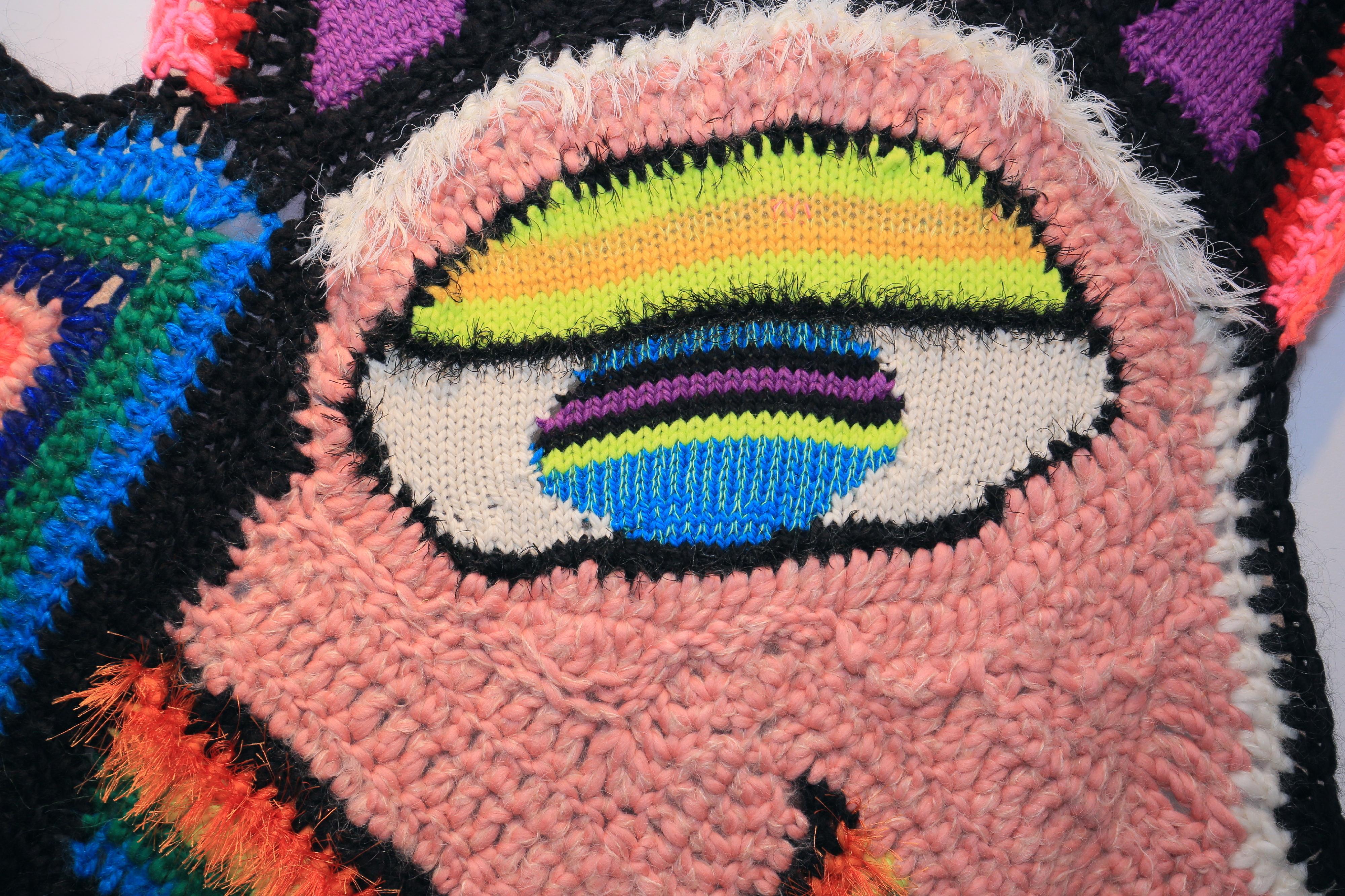 Arte tessile, arte fatta a mano, coperta artistica a maglia e all'uncinetto, arazzo lavorato a maglia, appeso alla parete, arte accessibile.
Il volto multicolore, astratto e geometrico si rivela all'interno di un patchwork arlecchino di motivi e