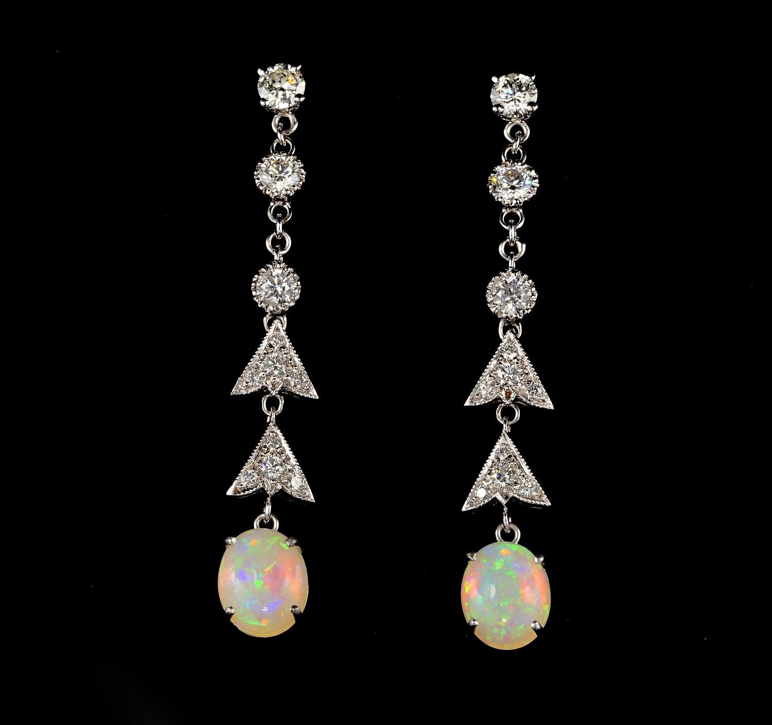 Exquisite in shape boasting a line of trilogy diamonds set as solitaires with gorgeous Diamond leaf work leading to the main Opal drop. 
Hand crafted as invidual piece of solid 18 KT gold.
italian origin 1950 ca.
Approx. 1.90 Ct of luxury diamonds