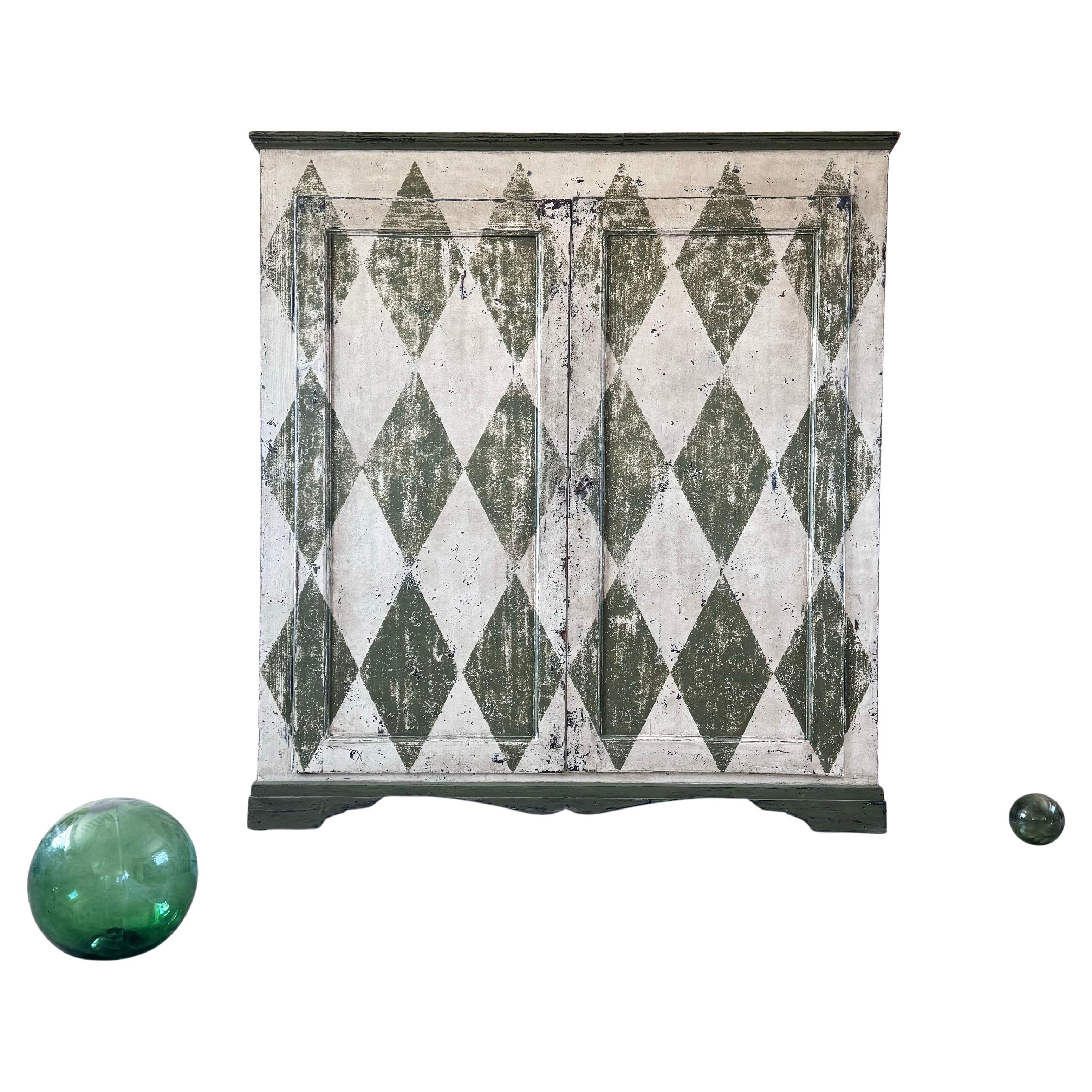 We sourced this striking antique, mid 19th Century cupboard in Florence, Italy.

Originally it was painted, but it was rather on the plain side so we have re-painted it with this giant harlequin design, breathing new life into a classic piece. The