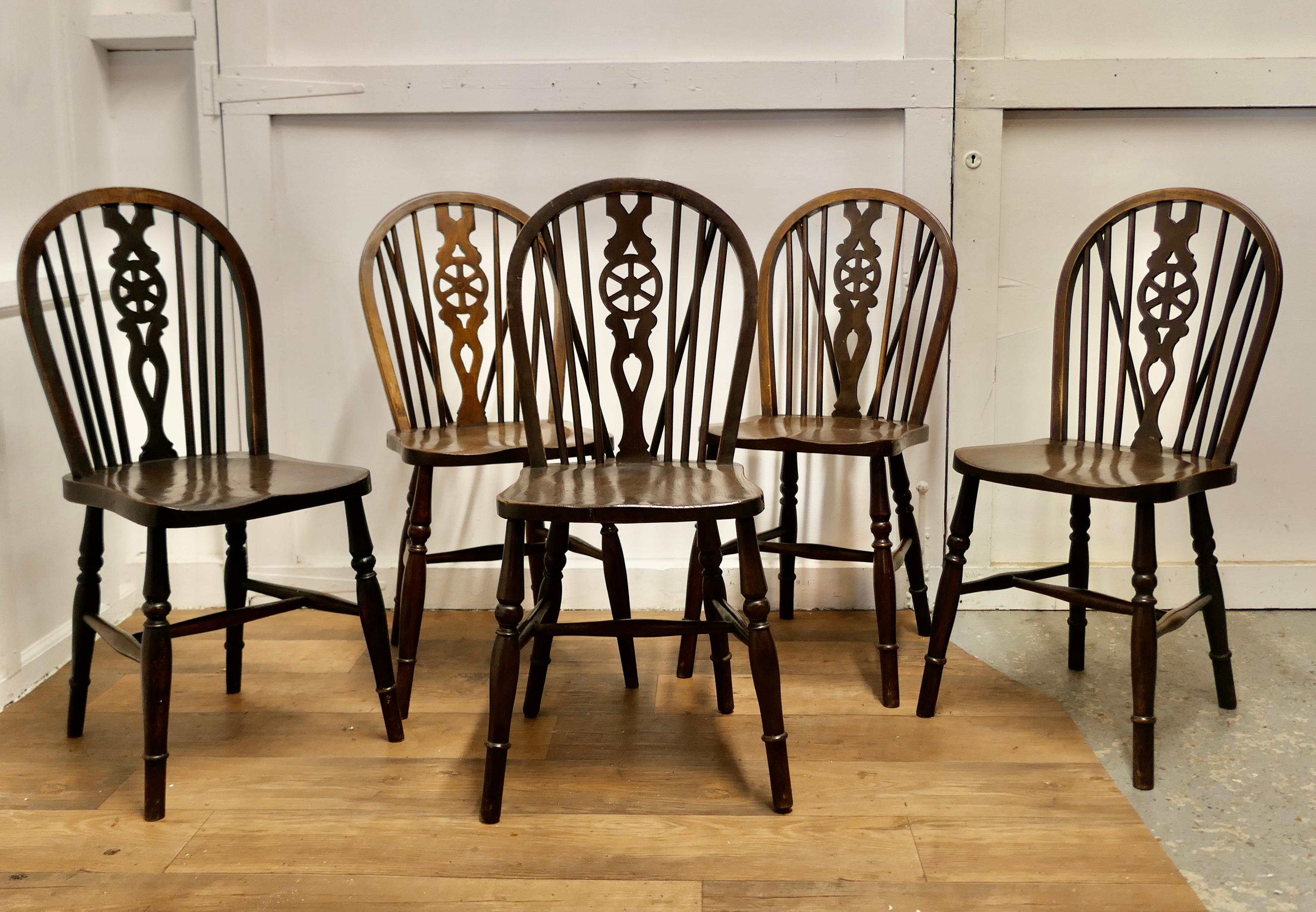 Harlequin Set of 5 Victorian Beech & Elm Wheel Back Windsor Kitchen Dining Chairs

The chairs are a classic design and traditionally made from solid wood they have hooped backs 4 of them have a wedge in the traditional Windsor style, the back centre