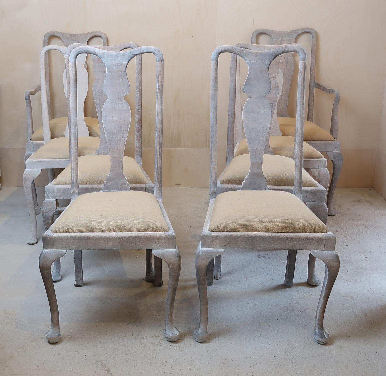 A set of 8 English limed oak chairs. Not quite matching. There are actually 4 different pairs. Two with arms

Each chair has a variation of the same basic characteristics. Firstly, the delightful urn back splat, secondly the unadorned cabriole or