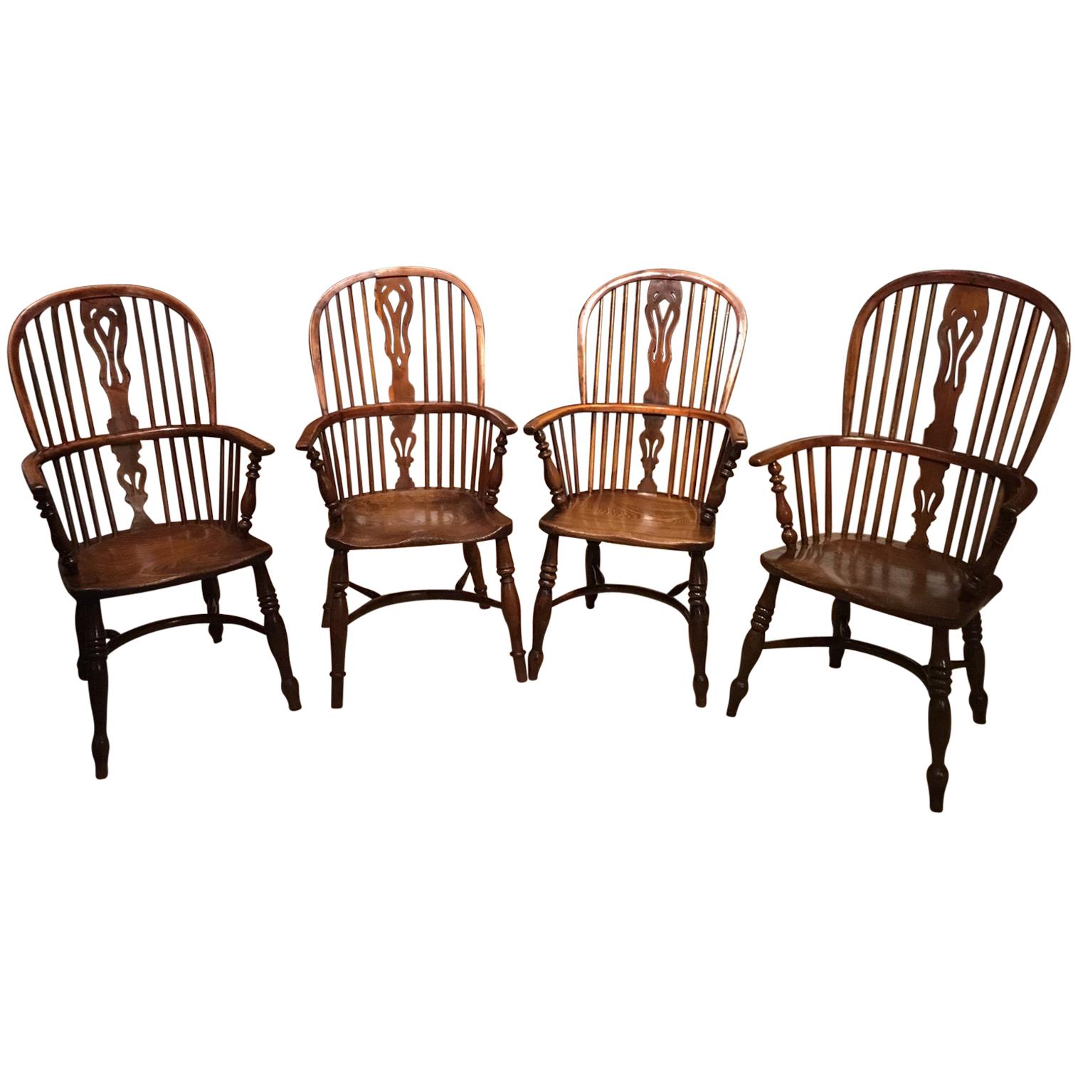 Harlequin Set of Four Yew Wood High Back Windsor Armchairs