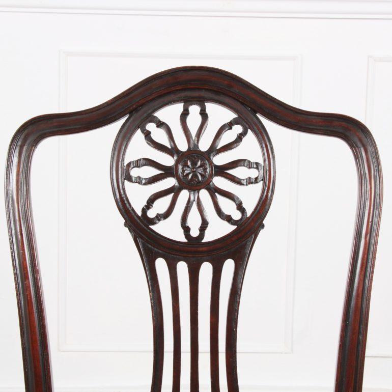 A ‘harlequin’ set of fifteen similar Georgian period (1800) and Edwardian period (1910) ‘Georgian Revival’ mahogany chairs, all with similar pierce-carved backs with variations on a ‘wheel’ motif and a variety of carved details. All have drop-in