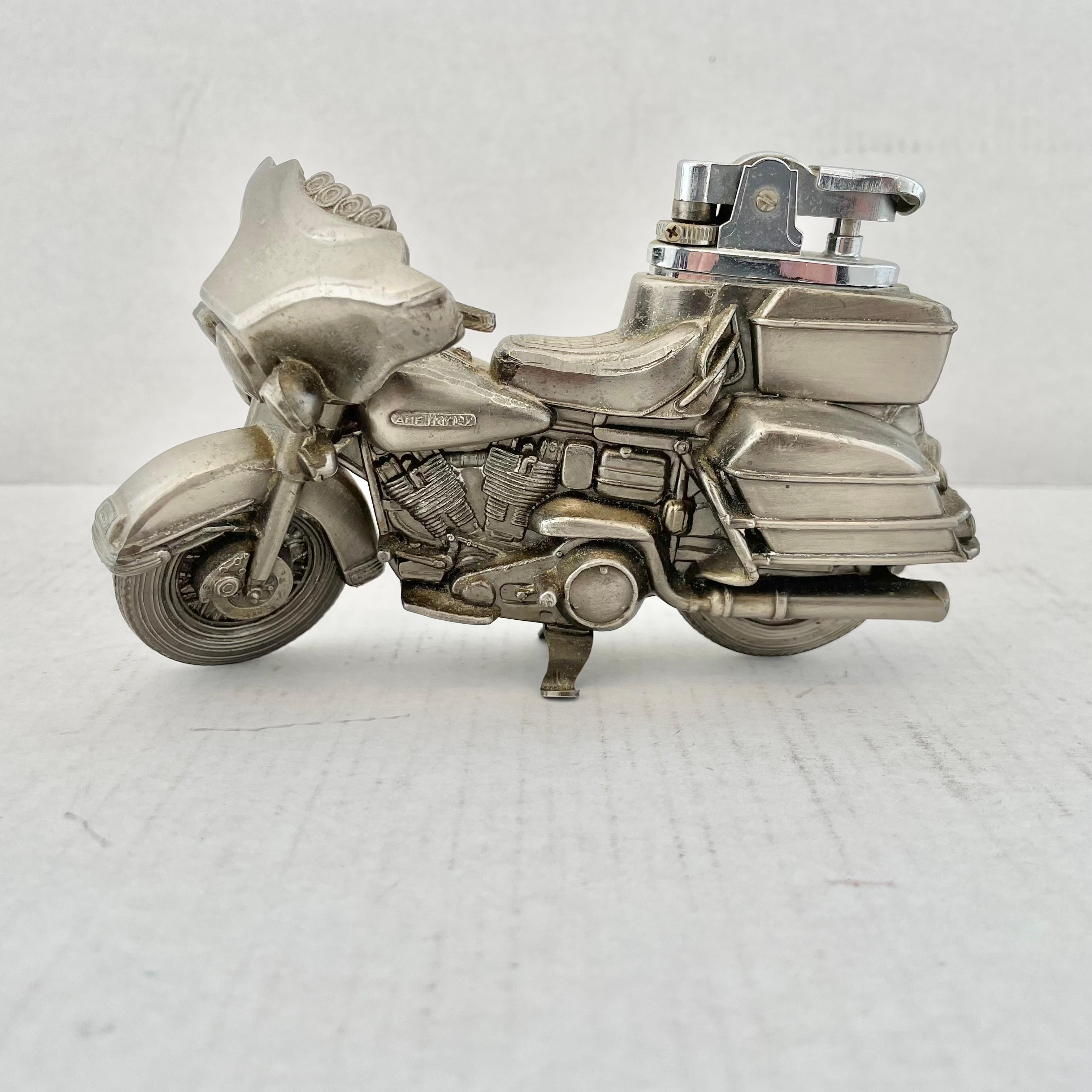 Cool vintage table lighter in the shape of a Harley Davidson Motorcycle. Made in Japan, 1980s. This piece has great balance and details. AMF Harley written on the gas tank and Japan written by the tail pipe. Cool tobacco accessory and conversation