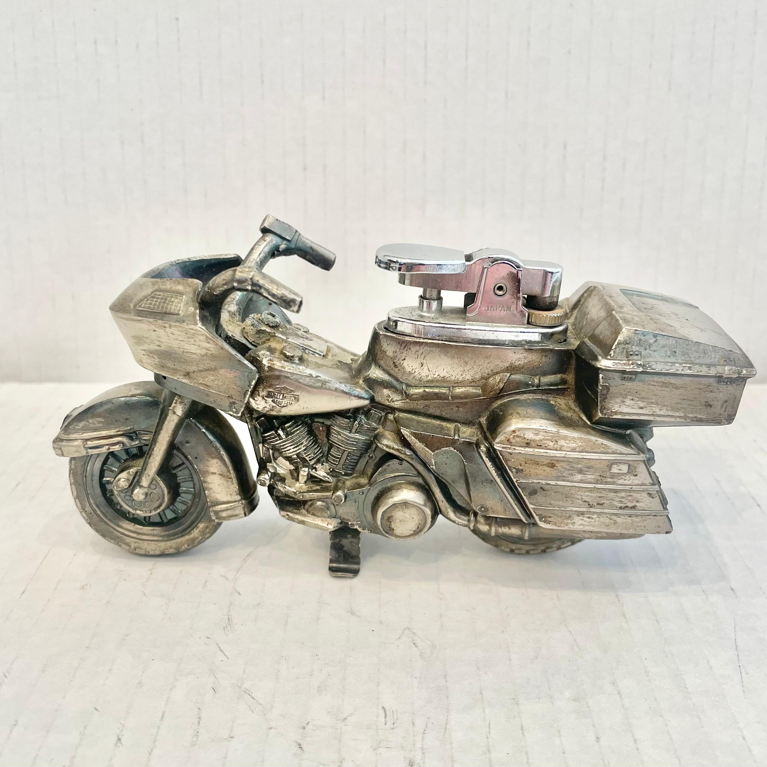 Cool vintage table lighter in the shape of a Harley Davidson Motorcycle. Made completely of metal with a hollow body. Great dark patina on the silver metal with great details. Cool tobacco accessory and conversation piece. Made in Japan in the
