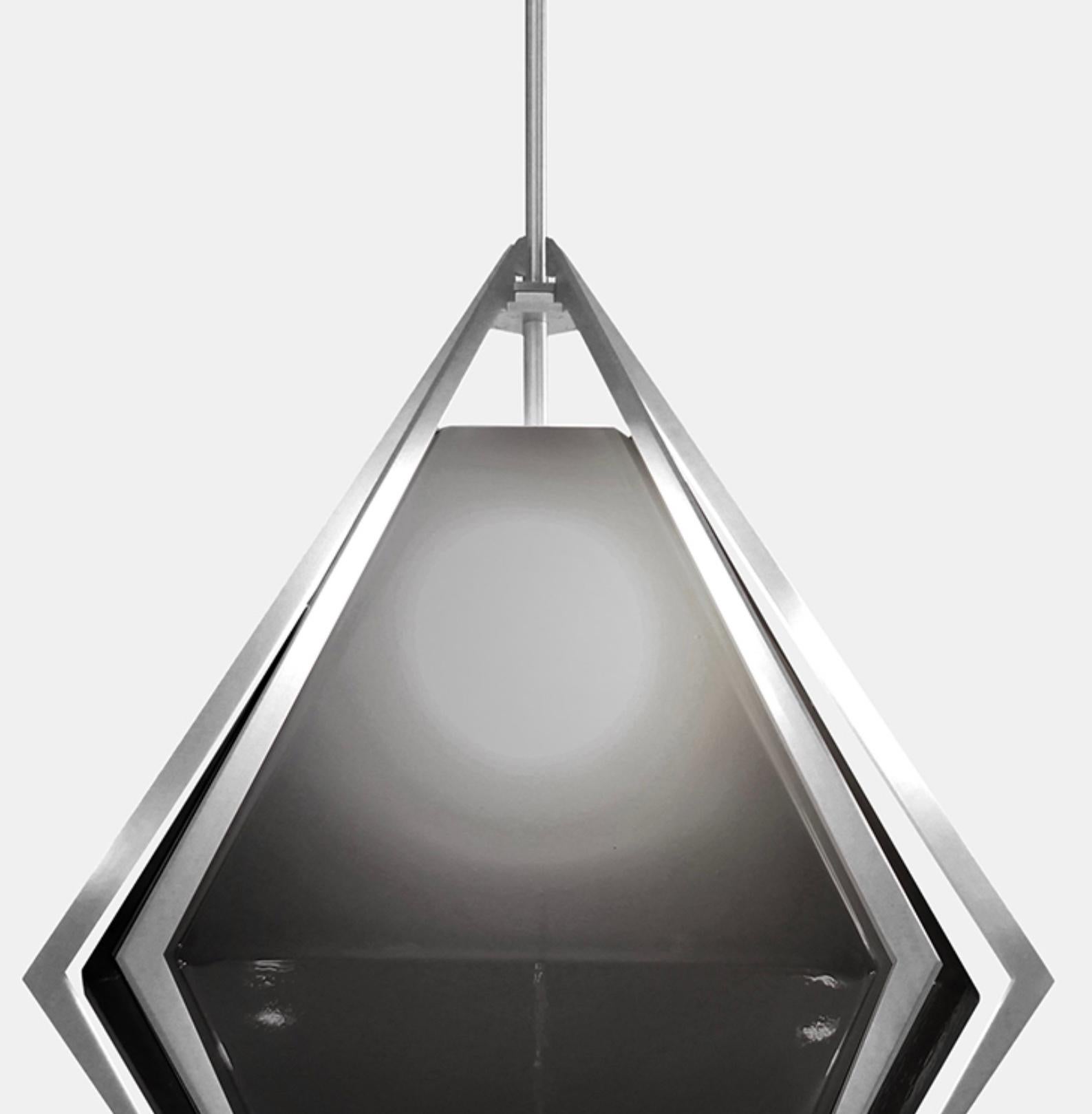 The Harlow Large Pendant offers an elegant starburst of light that reflects and refracts through its mold-blown glass shade. A sparkling prism, the Harlow Large Pendant is directly inspired by the world of jewelry with its metallic frame encasing a