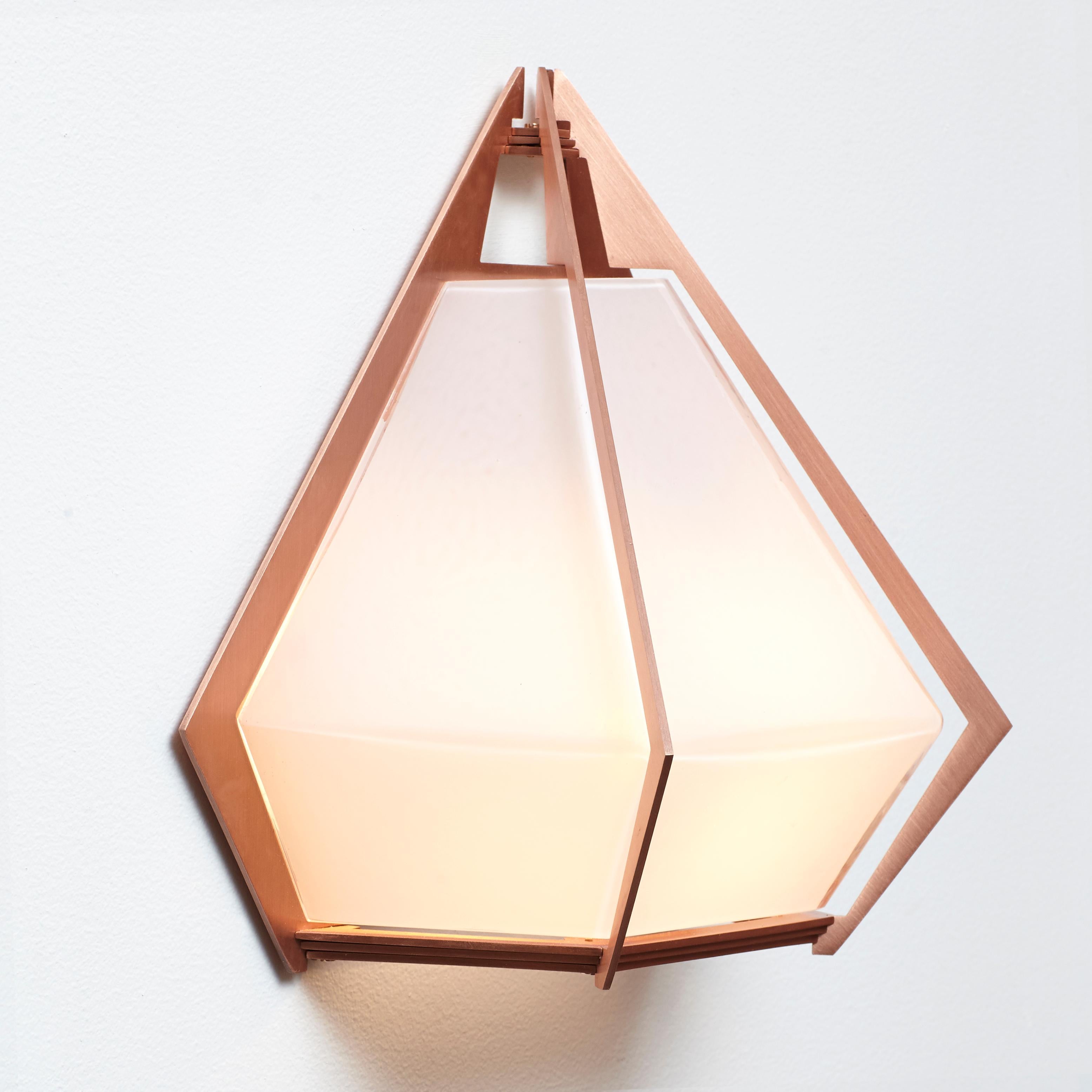 The Harlow Wall Sconce offers an elegant starburst of light that reflects and refracts through its mold-blown glass shade. A sparkling prism, the Harlow Wall Sconce is directly inspired by the world of jewelry with its metallic frame encasing a