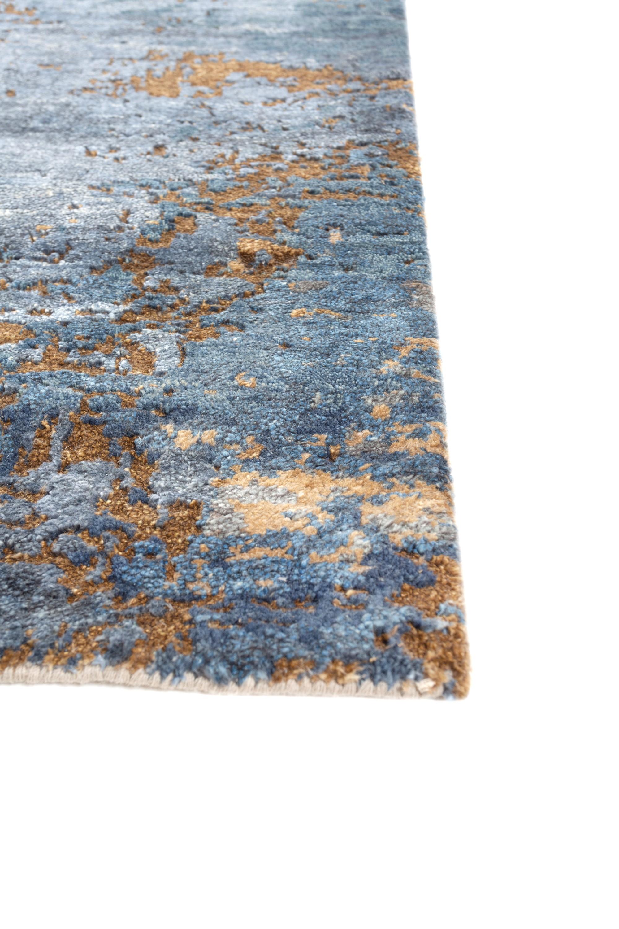 In the ebb and flow of civilizations, find peace in disorder with this hand-knotted rug  that mirrors the gradual decline to chaos. Within its intricate patterns lies a hypnotic sense of calm and peace. Handmade in rural India, this modern rug is a