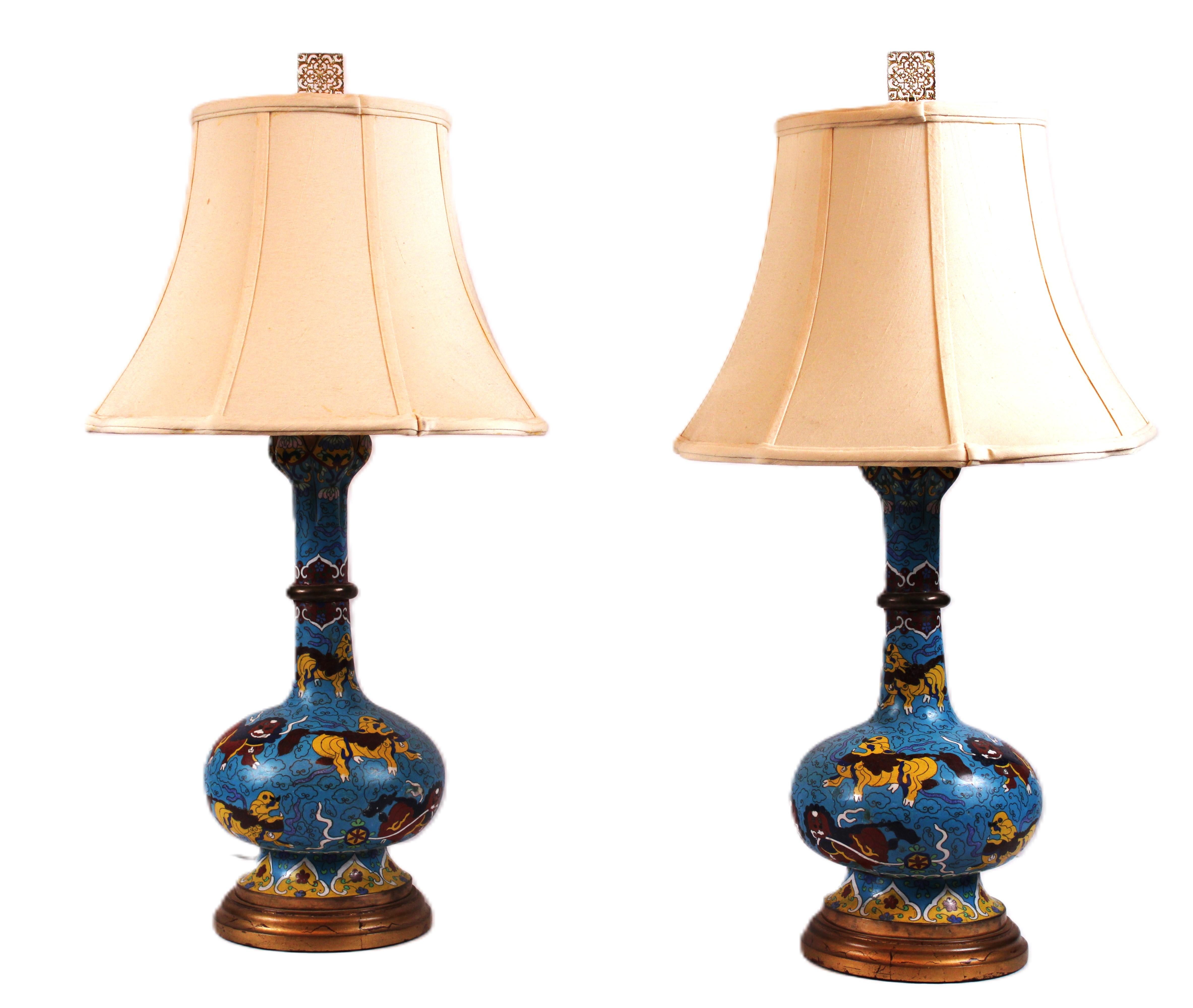 These cloisonné lamps stand as a testament to timeless craftsmanship. Each lamp is a symphony of artistry, meticulously crafted by skilled hands.

The deep blue cloisonné base serves as the canvas for intricate golden motifs. The enamels,