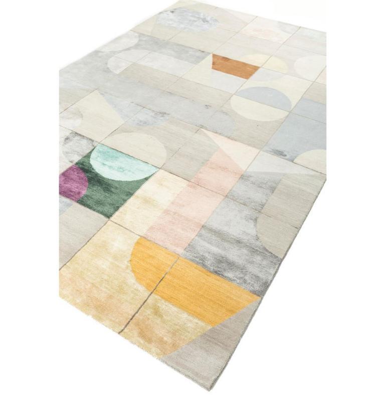 Embark on a journey of contemporary elegance with this hand-knotted geometric rug. Intricate mazes and jigsaws, rendered in bold, abstract designs, form a captivating tapestry of creativity. Crafted from the finest quality wool and bamboo silk, this