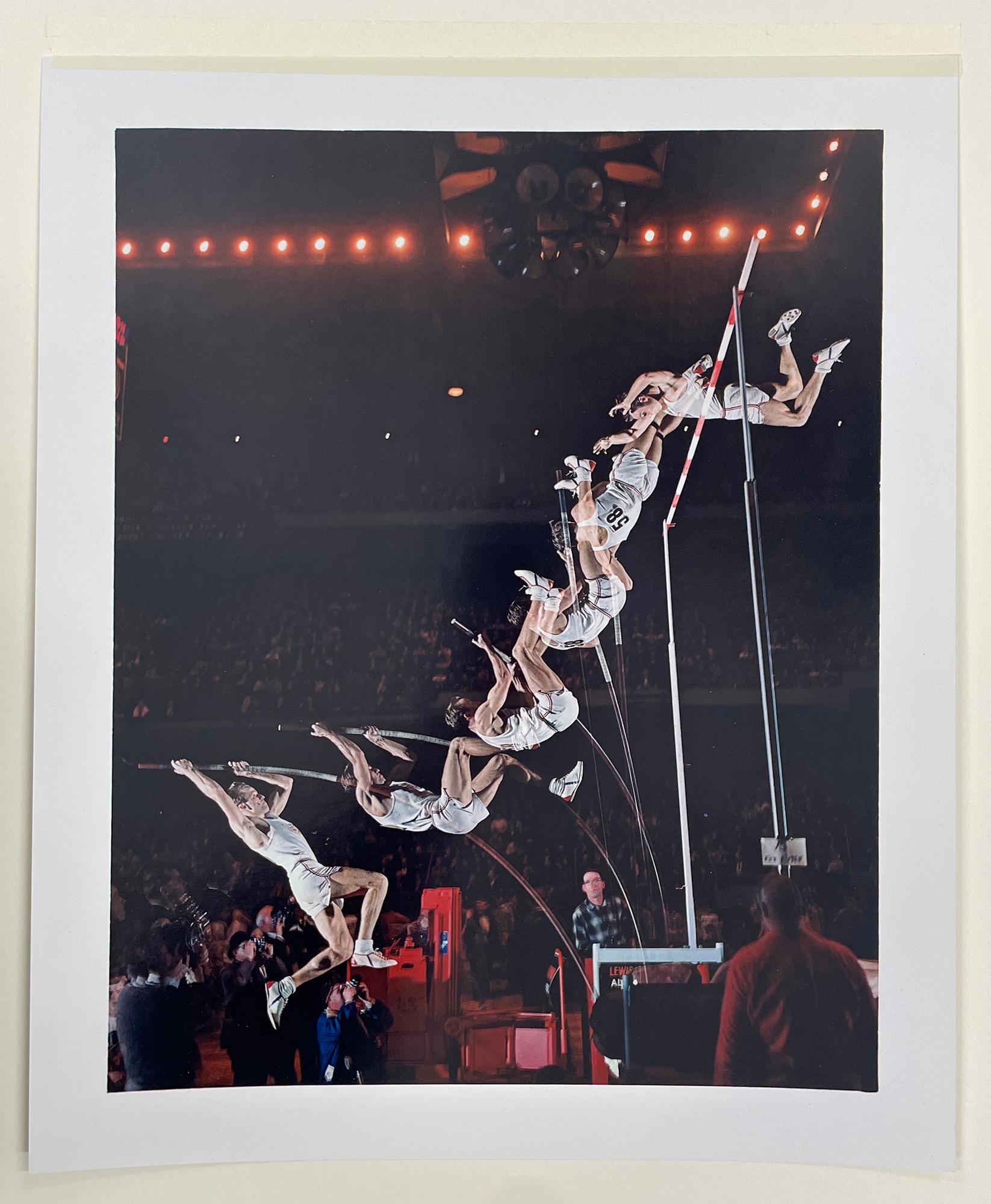Pole Vault by Harold Edgerton is a color photograph of an athlete performing a pole vault. Edgerton captures multiple images of the pole vaulting process in one photograph, reminiscent of photographer Eadweard Muybridge's studies of motion. 

Dye