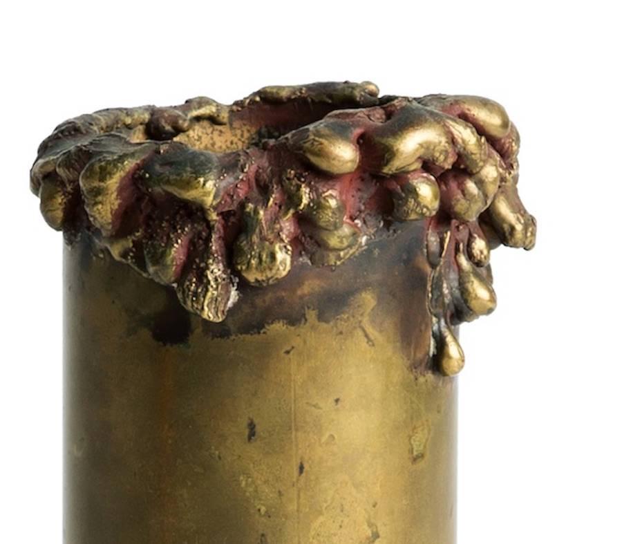 Bronze vase with heavy patina and wet sand motif on the top edge.

The piece is marked 