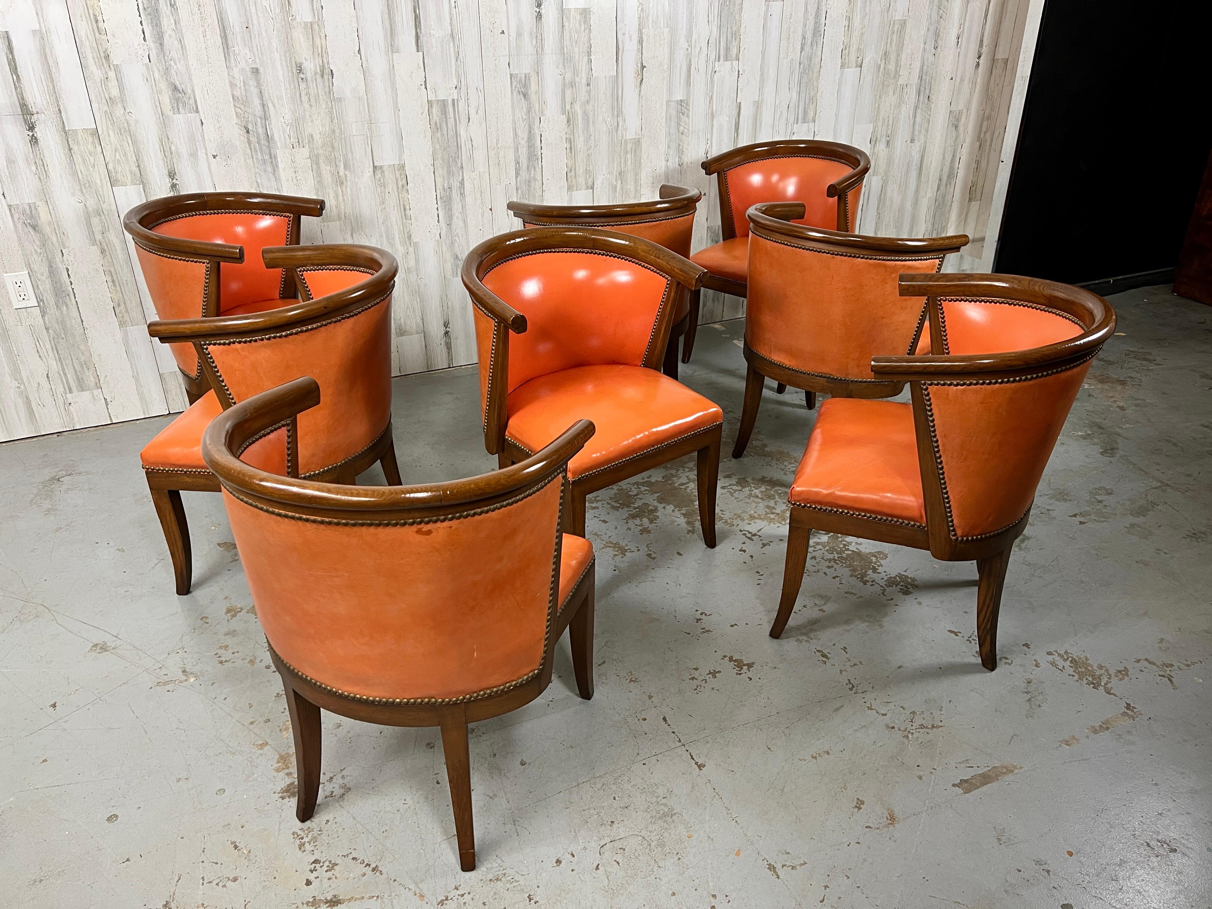 Set of 8 oak horseshoe barrel back dining chairs with original orange leather. Designed by Harold Schwartz for Romweber furniture company these chairs are very comfortable and sturdy.