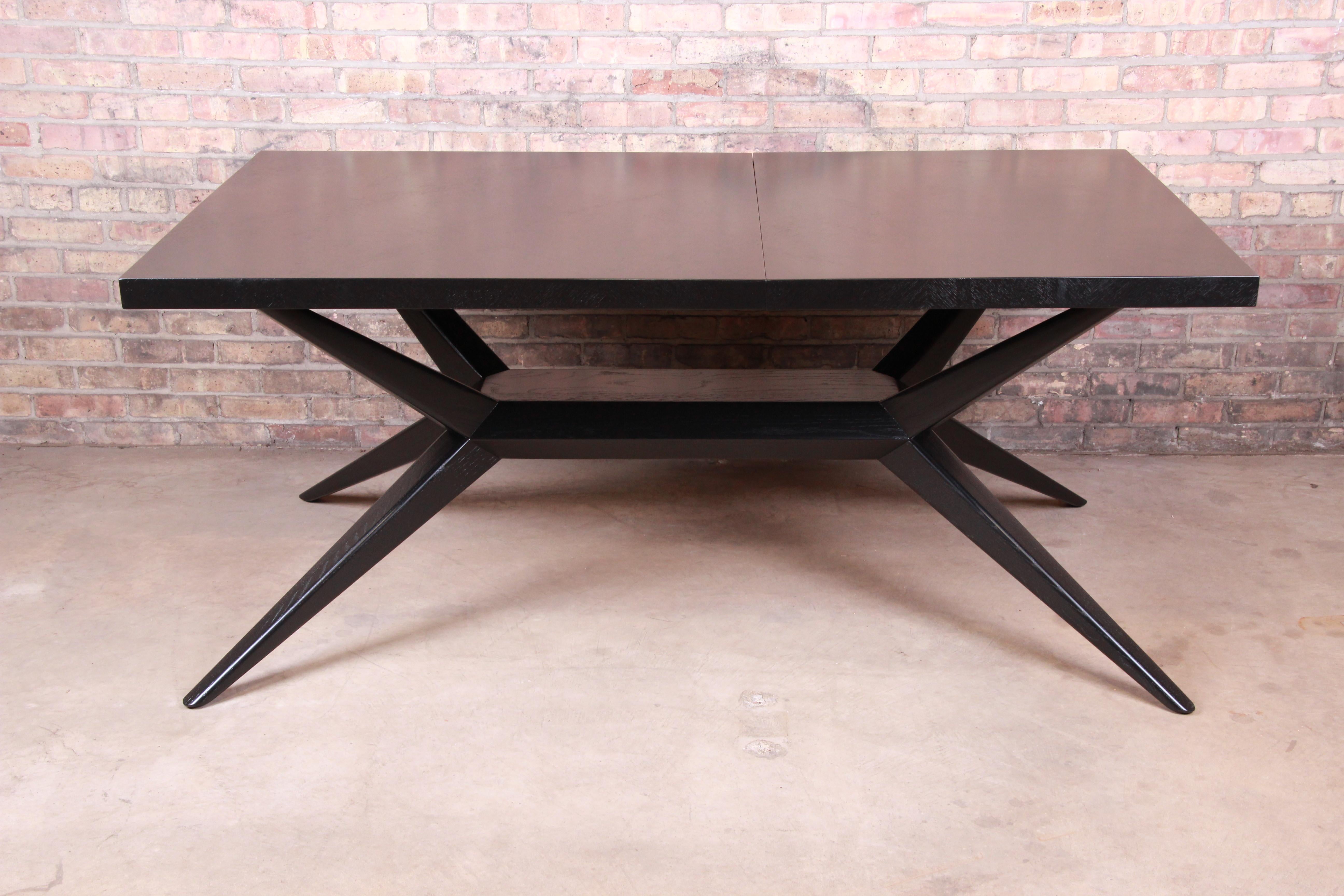 A rare and exceptional Mid-Century Modern extension dining table

By Harold Schwartz for Romweber

USA, 1950s

Ebonized mahogany with parquetry top, sculpted solid mahogany splayed spider legs, and unique built-in cutlery drawers on each