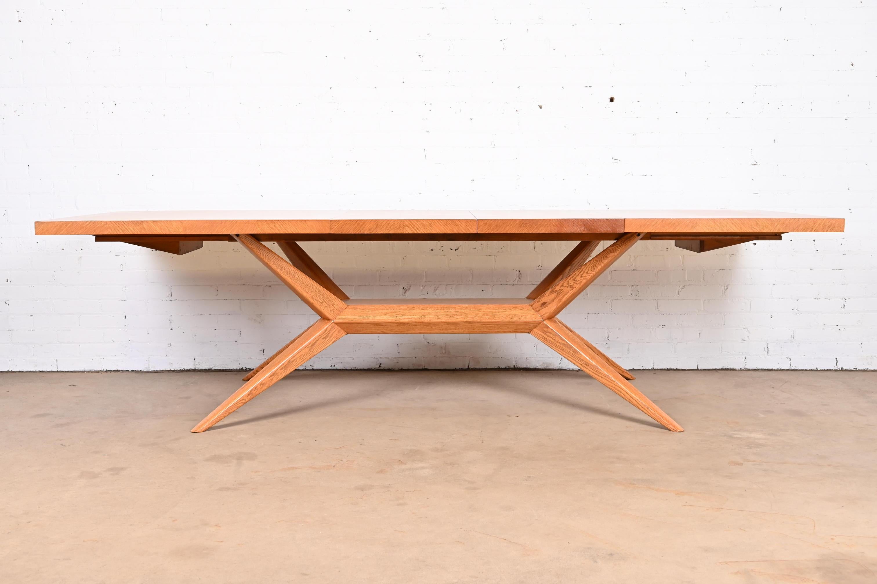 A rare and exceptional Mid-Century Modern extension dining table

By Harold Schwartz for Romweber

USA, 1950s

Sculpted oak with parquetry top, splayed spider legs, and unique felt-lined cutlery drawers on each end.

Measures: 70