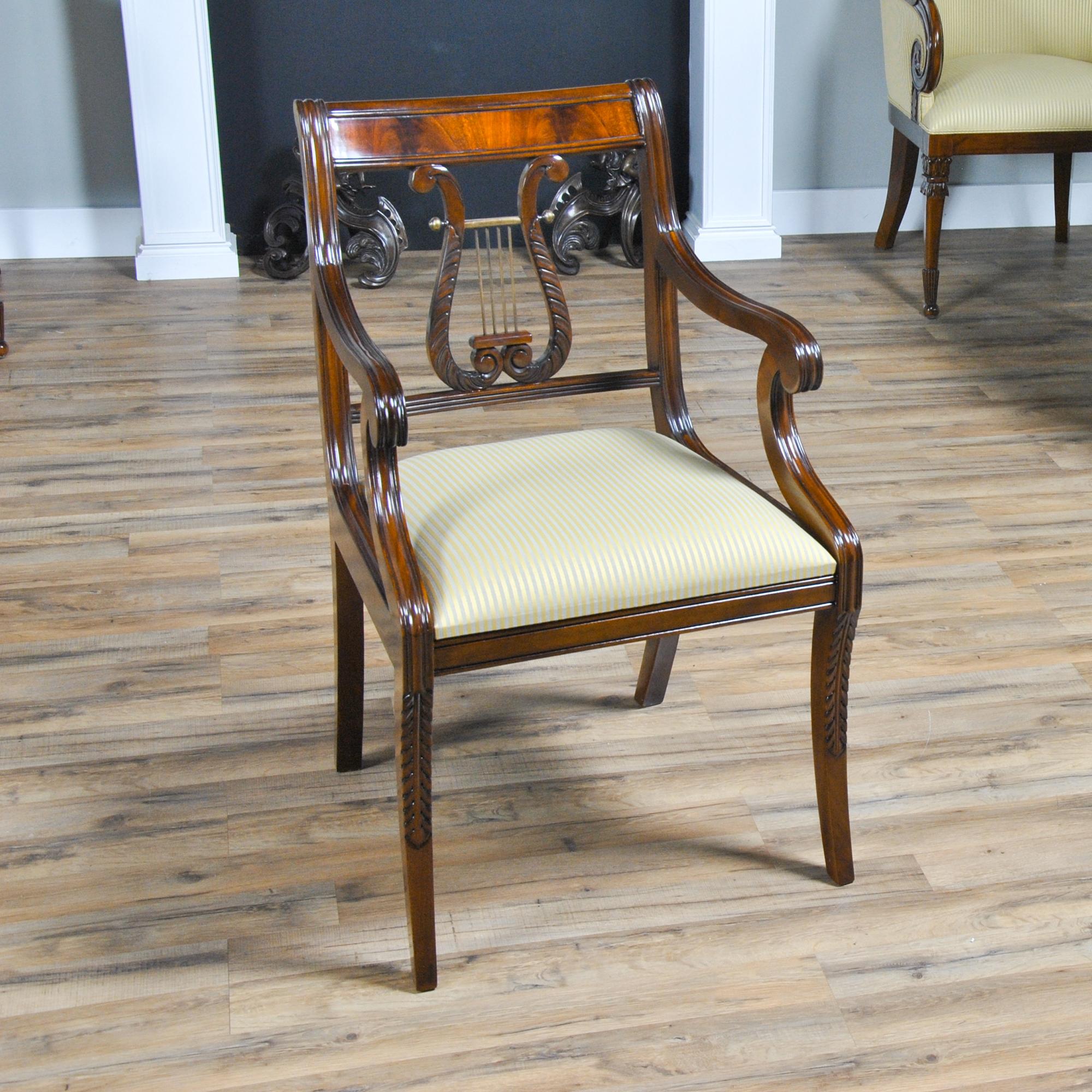 This fine quality set of ten Lyre Chair or Harp Back Chairs consist of 2 arm chairs and eight side chairs. Each chair proudly displays hand carved details throughout it’s entire construction. Top rails feature figured mahogany veneers and the center
