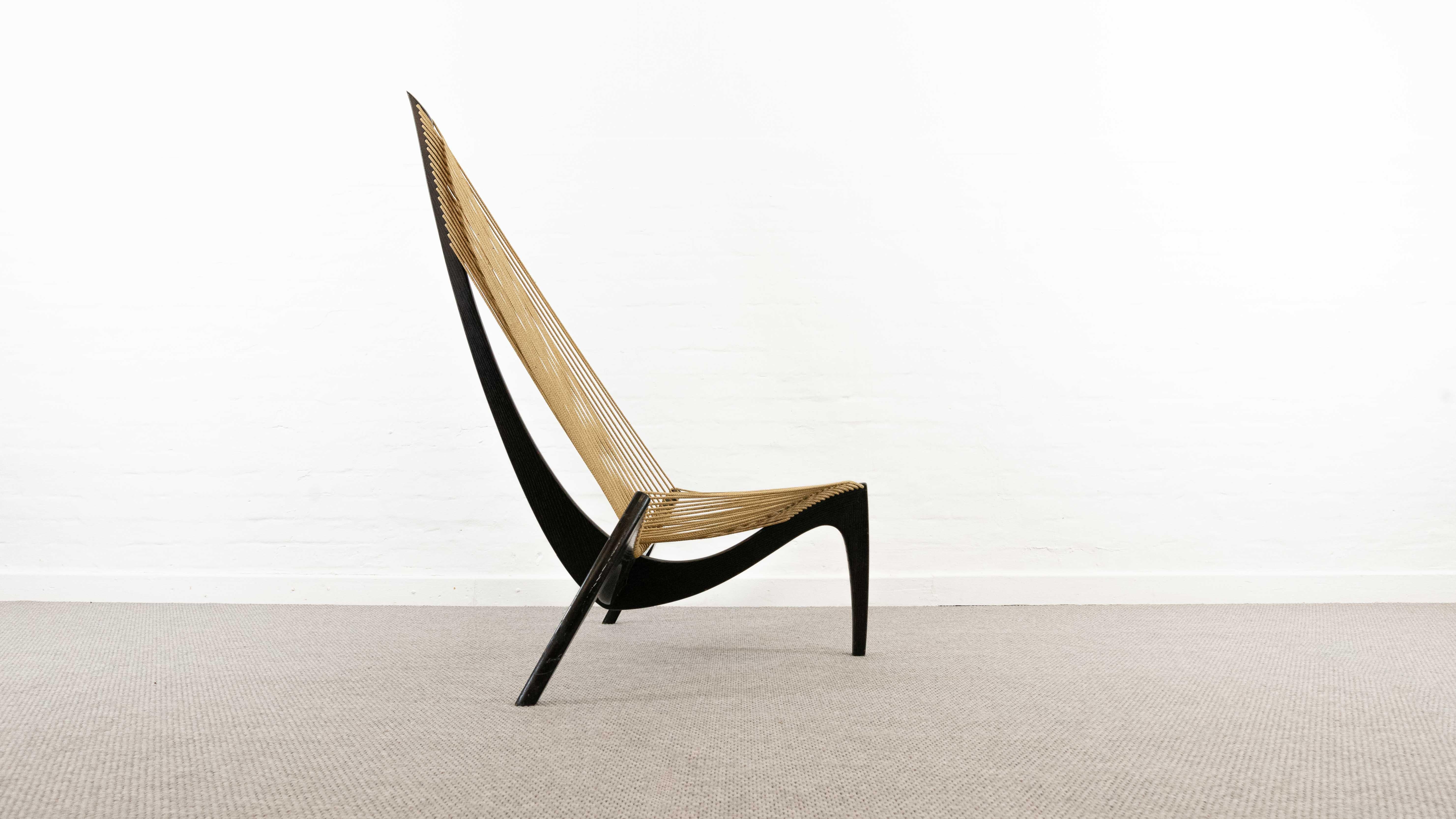 Vintage Harp chair designed by Jørgen Høvelskov 1968. Made of black lacquered ash wood and flag rope. The curves of the wooden legs refer to a ship’s bow from a Viking ship. The legs are joined with a single metal screw. Beautiful iconic seating