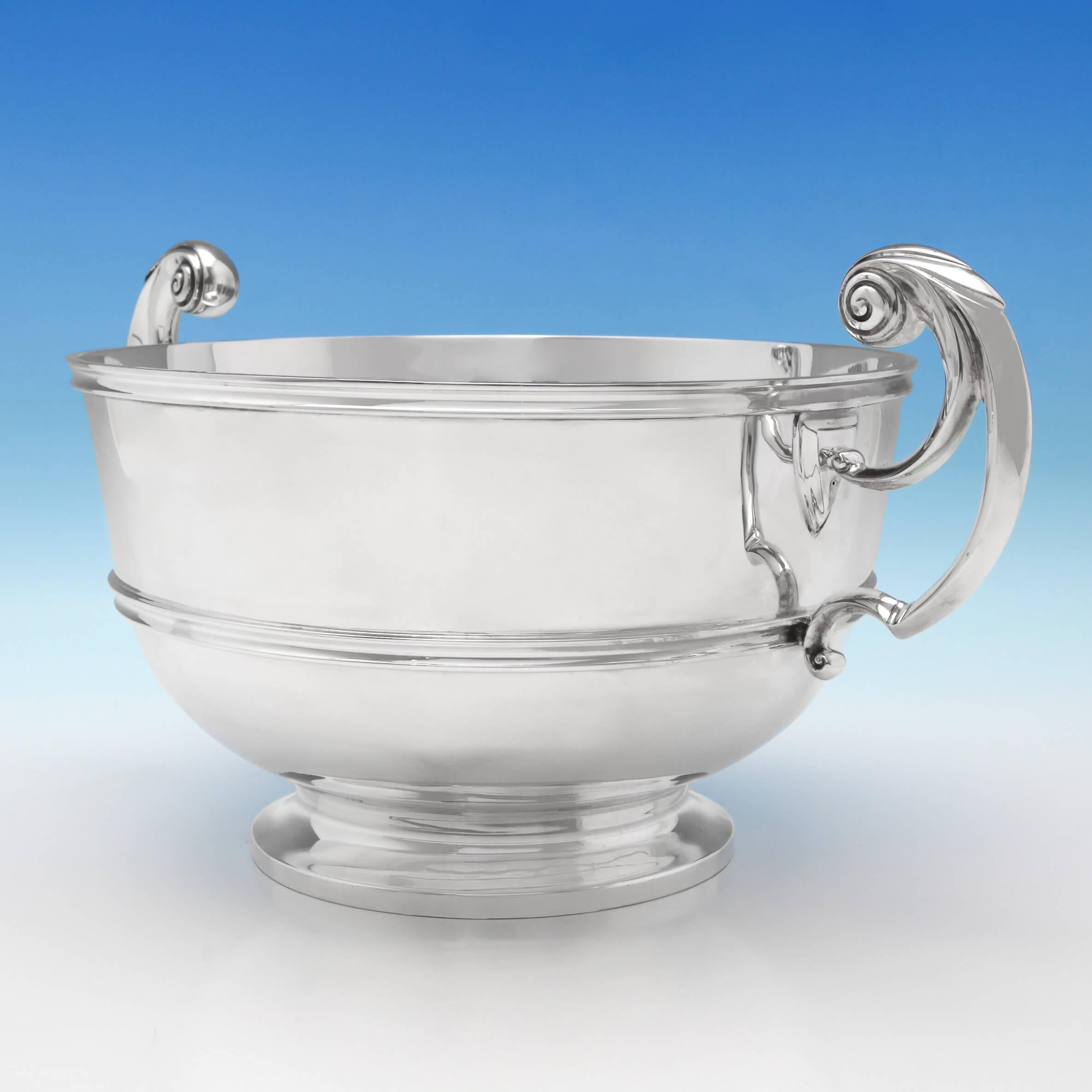 Hallmarked in London in 1903 by Charles Stuart Harris, this handsome, Edwardian, Antique Sterling Silver Bowl, stands on a pedestal base, and features harp handles and reed detailing. 

The bowl measures 7.5