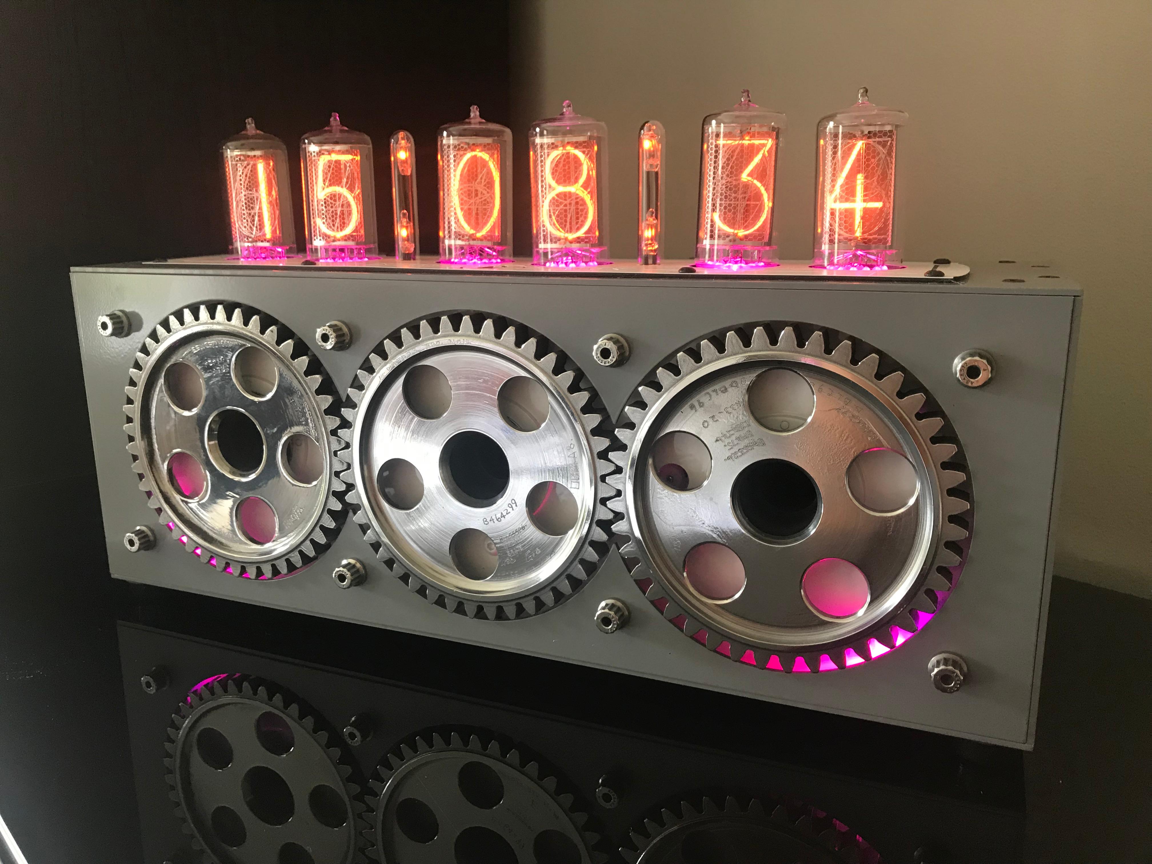 Designed by Intrepid Design using parts from a Harrier Jump Jet engine, we have created a limited number of Cog Nixie Clocks. The Nixie tube, or cold cathode display is an electronic device for displaying numbers using glow discharge.

The clock
