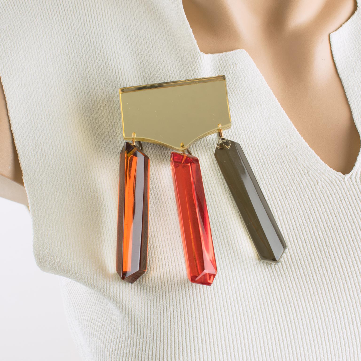 Harriet Bauknight for Kaso designed this stunning, massive Acrylic resin brooch. The rare Lucite piece boasts a geometric and dimensional design with dangling long charms in assorted fall colors of yellow champagne, gold honey, burnt orange, and